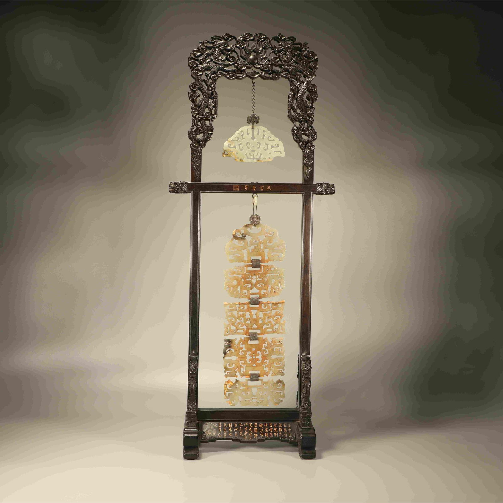 A SET OF ZITAN CARVED DRAGON-PATTERN JADE BI PENDANTS (1 of 8)