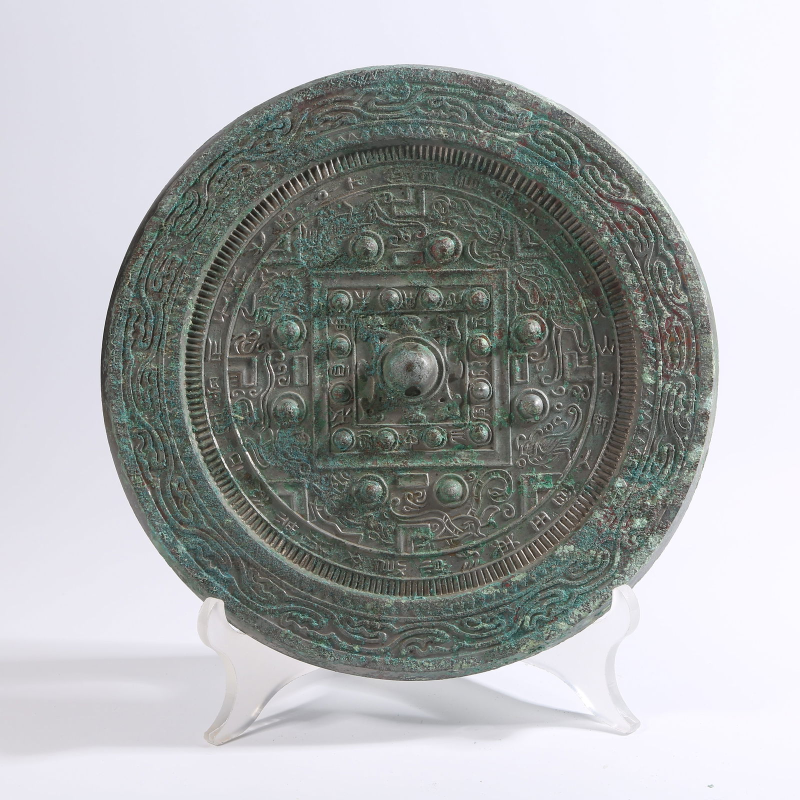 A PRE-HAN BRONZE MIRROR WITH DIVINE PHOENIX MOTIFS: Pre-Han bronze mirror with divine phoenix motifs