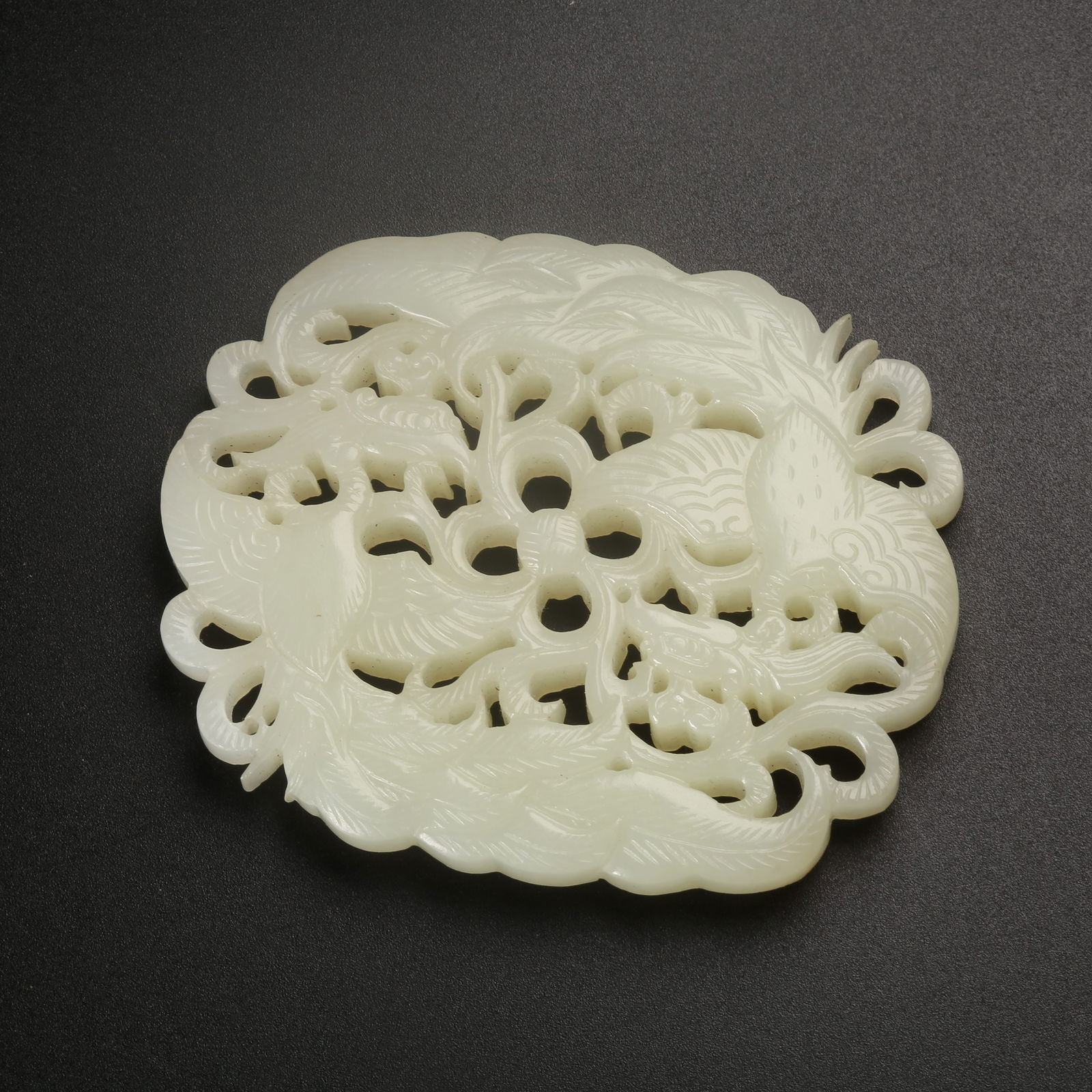 A HETIAN JADE PENDANT WITH FLOWER-PIERCED PHOENIX MOTIF (1 of 8)