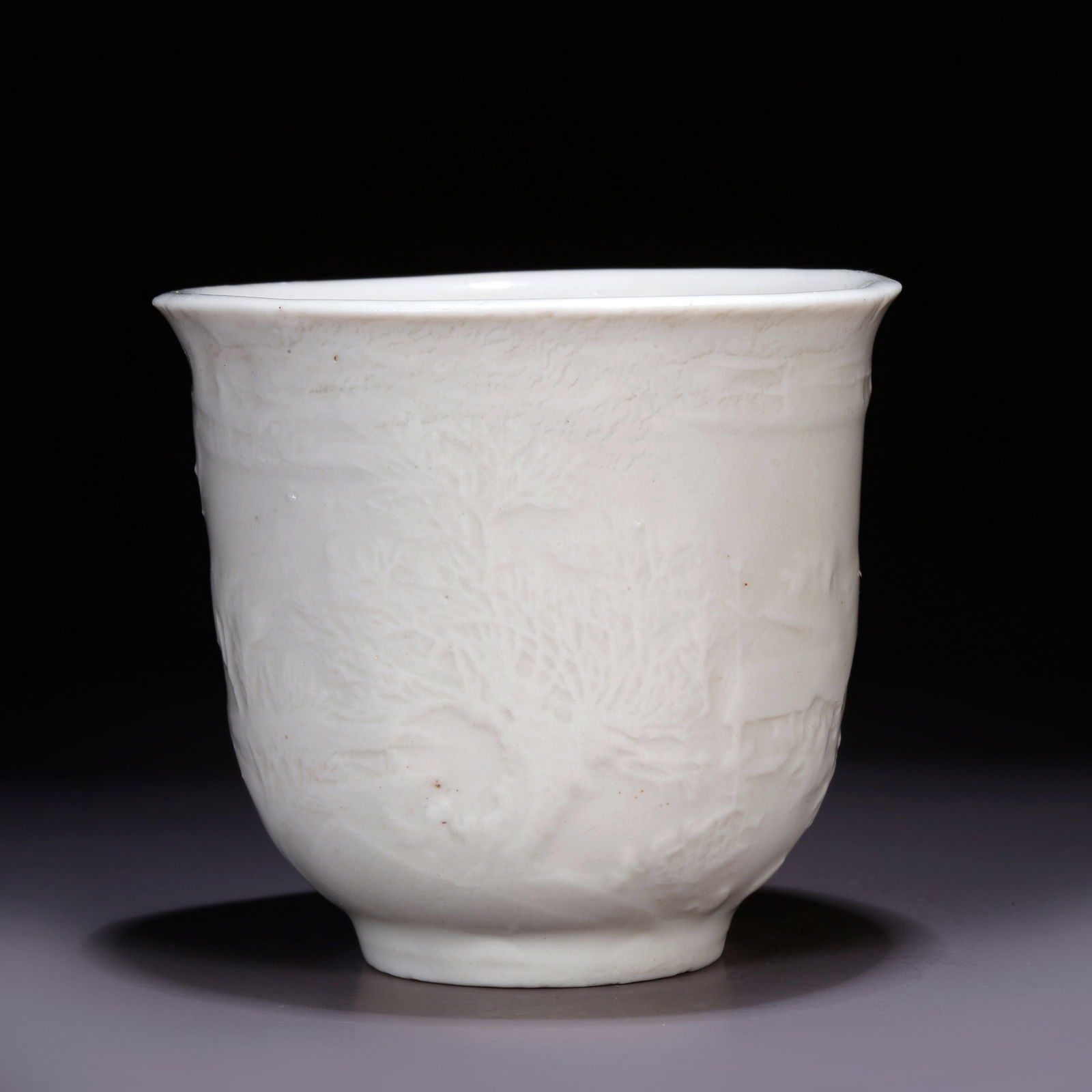 A DEHUA WHITE PORCELAIN CUP WITH LANDSCAPE DESIGN: Dehua White Porcelain Cup with Landscape Design