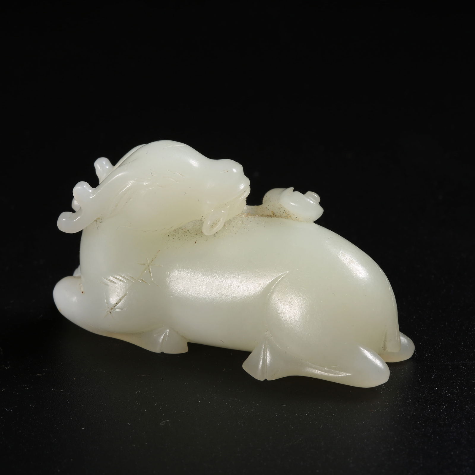 A HETIAN JADE ORNAMENT OF A SACRED DEER WITH LINGZHI (1 of 8)