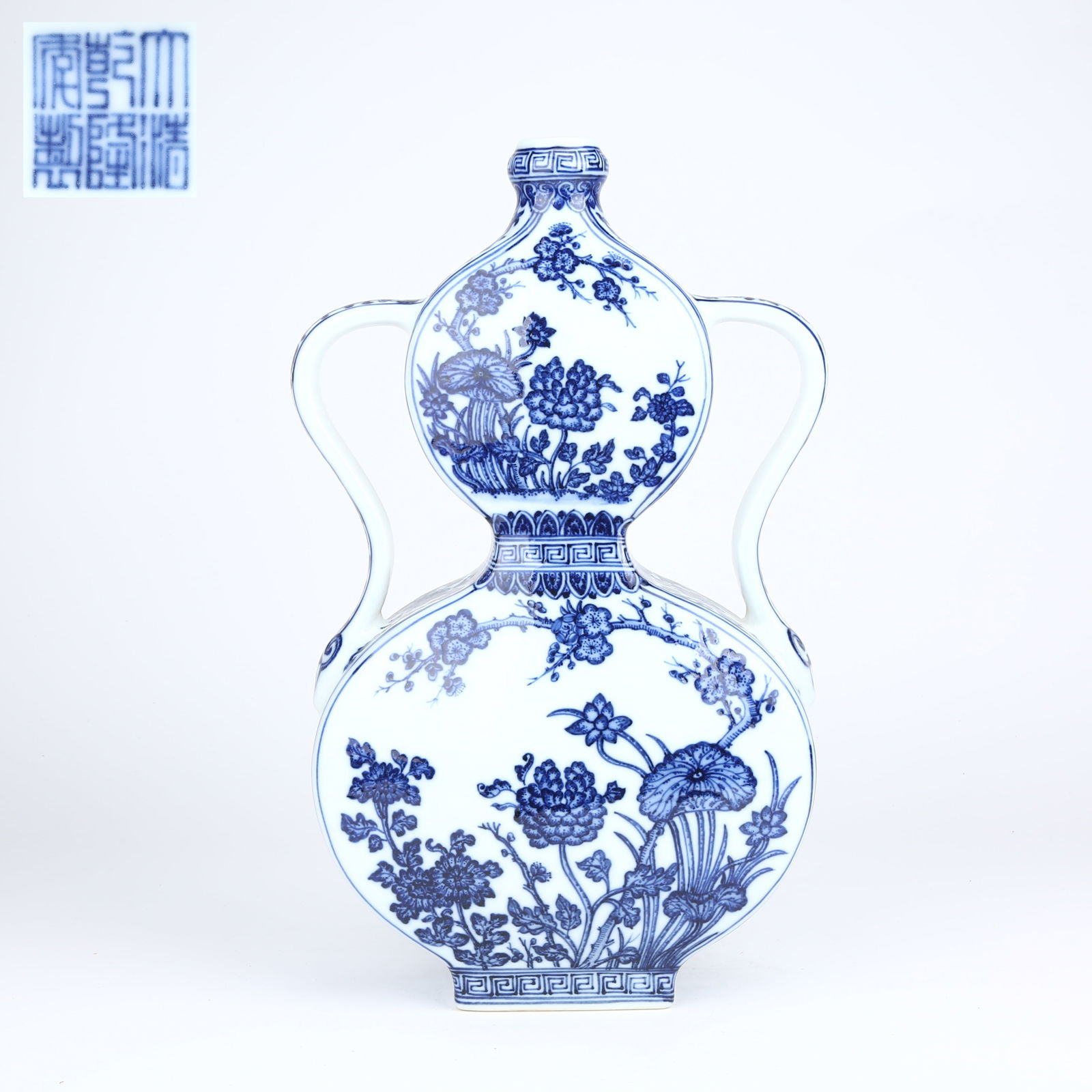 A BLUE-AND-WHITE FOUR SEASONS FLORAL PATTERNED RIBBON-HANDLED GOURD VASE: Blue-and-White Four Seasons Floral Patterned Ribbon-Handled Gourd Vase
