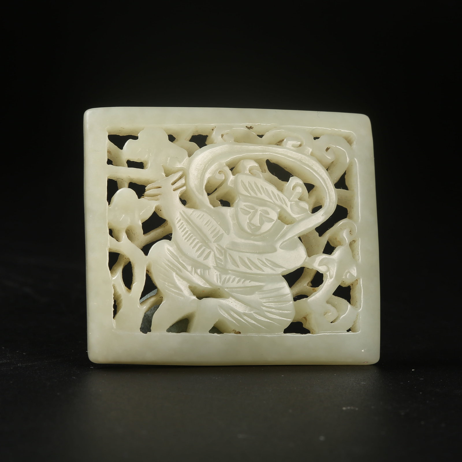 A HETIAN JADE BELT ORNAMENT WITH HU FIGURE MOTIF: Hetian Jade Belt Ornament with Hu Figure Motif