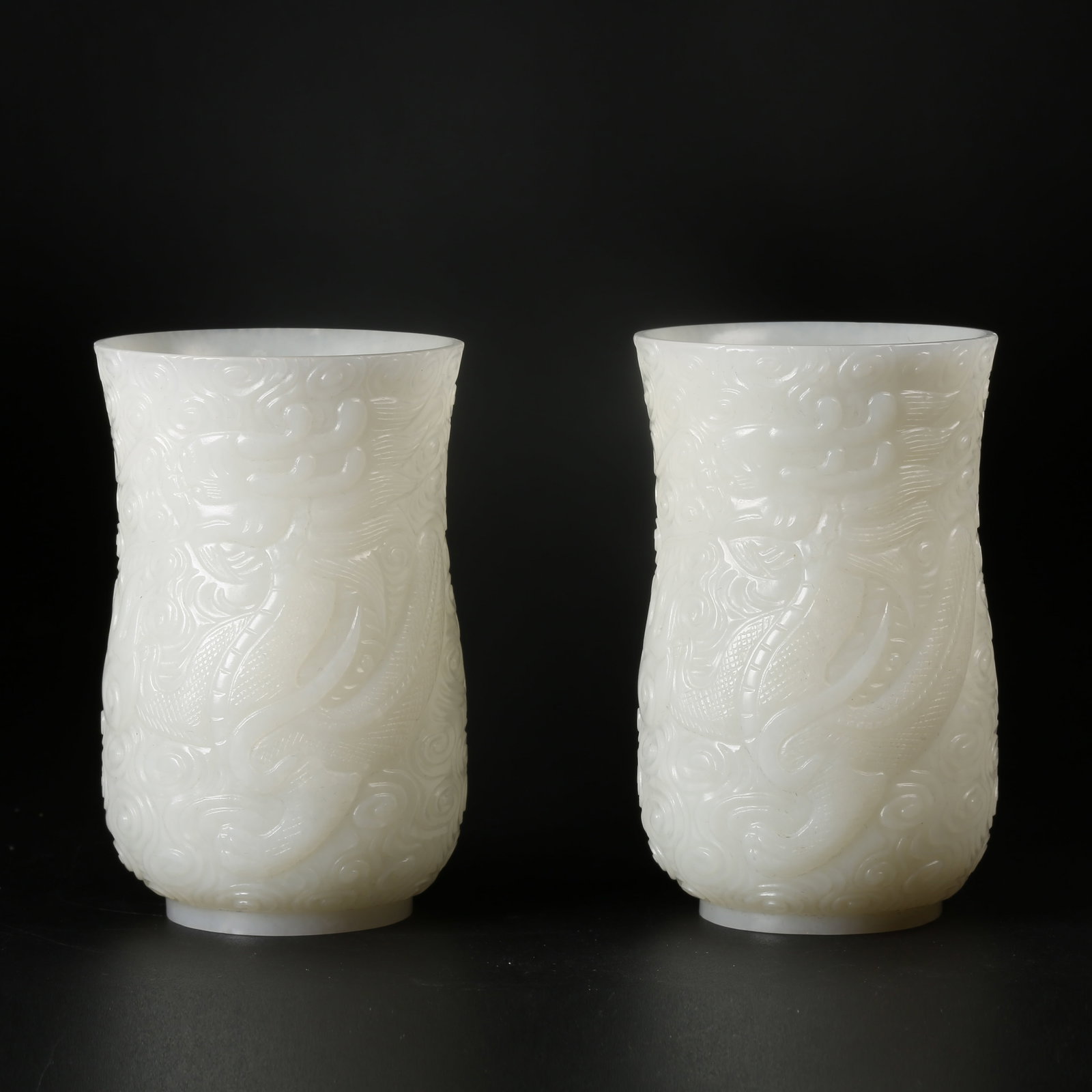 A HETIAN WHITE JADE CUPS WITH CLOUD AND DRAGON MOTIF (SET): Hetian White Jade Cups with Cloud and Dragon Motif (Set)