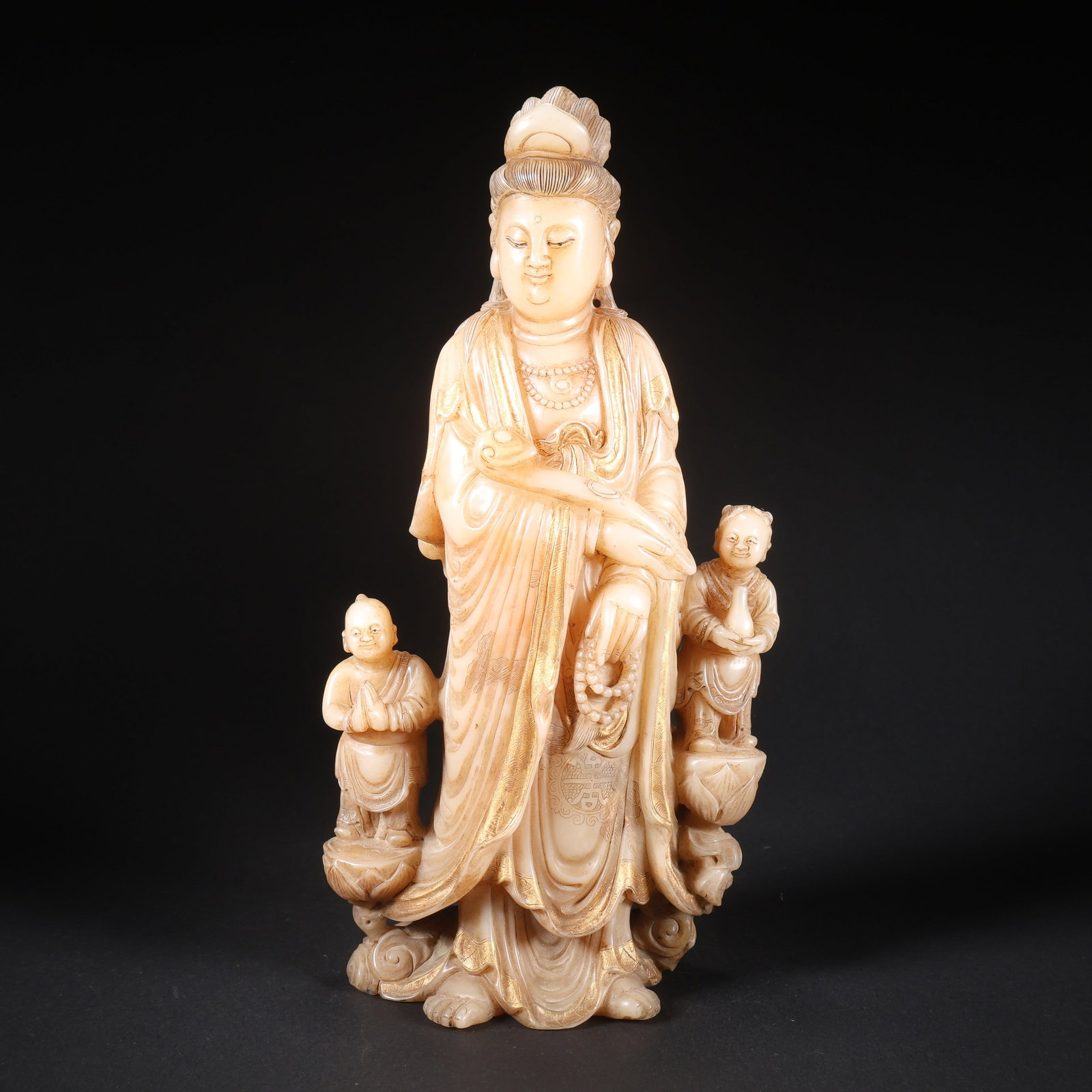 A WHITE TIANHUANG STONE LOTUS WITH CHILD ACCOMPANYING GUANYIN (1 of 9)