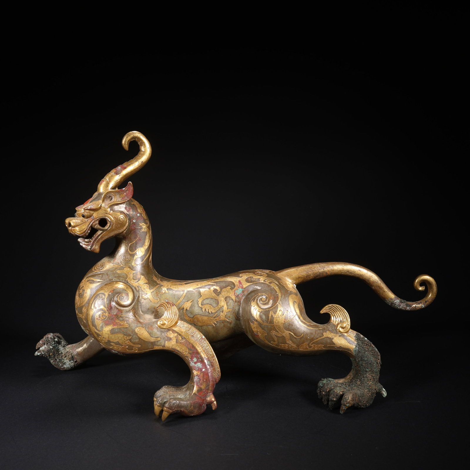 A GILT BRONZE AUSPICIOUS BEAST INLAID WITH TURQUOISE, HEAD TURNED LEFT (1 of 9)