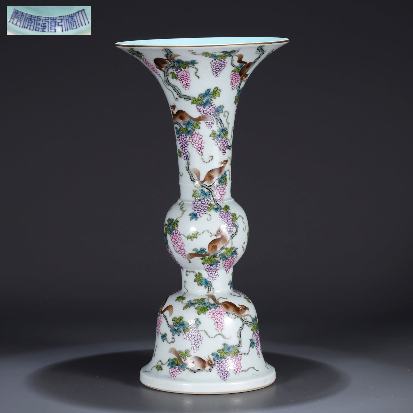 A FAMILLE ROSE FLOWER GOBLET WITH SQUIRREL AND GRAPE DESIGN: Famille rose flower goblet with squirrel and grape design