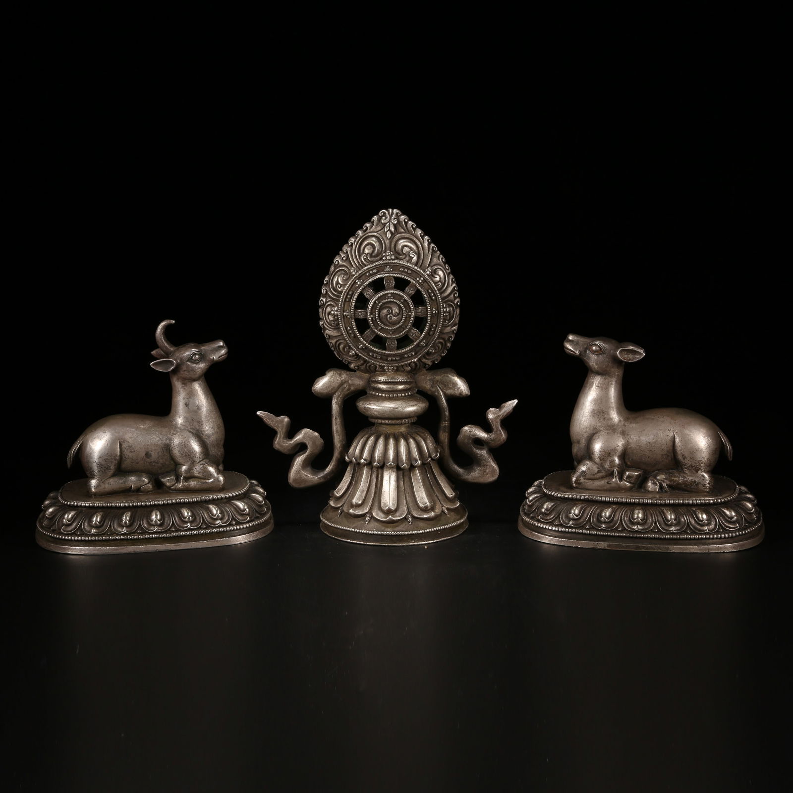 A TIBETAN SILVER PAIR OF DEER WITH DHARMA WHEEL (SET): Tibetan Silver Pair of Deer with Dharma Wheel (Set)