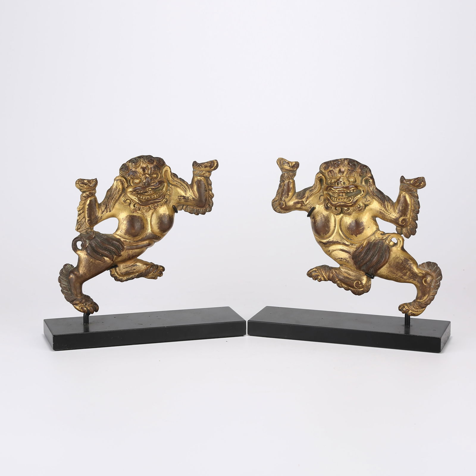 A GILDED BRONZE SET OF GUARDIAN LIONS: Gilded bronze set of guardian lions