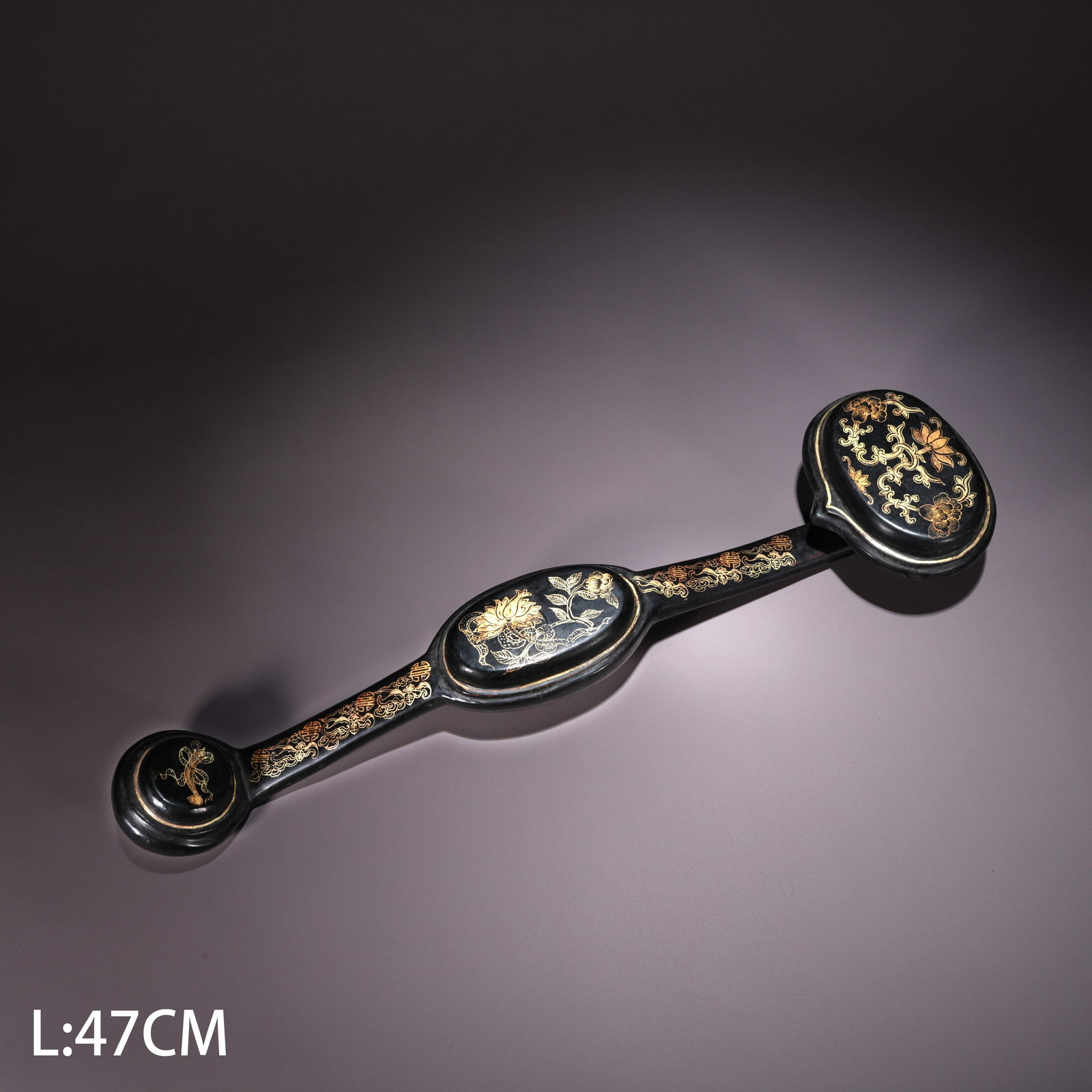 A LACQUER RUYI WITH GILT FLOWER MOTIFS: Lacquer Ruyi with Gilt Flower Motifs