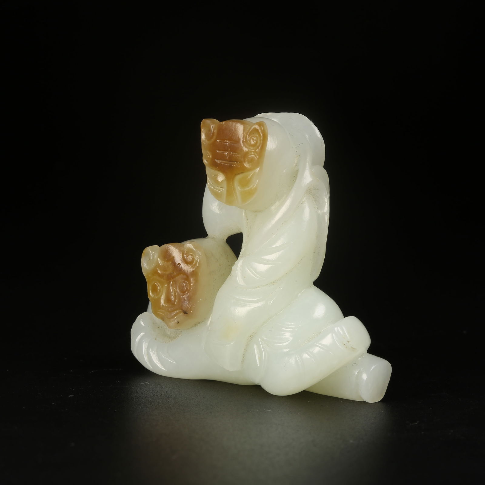 A HETIAN JADE CHILD HOLDING LOTUS ORNAMENT: Hetian Jade Child Holding Lotus Ornament