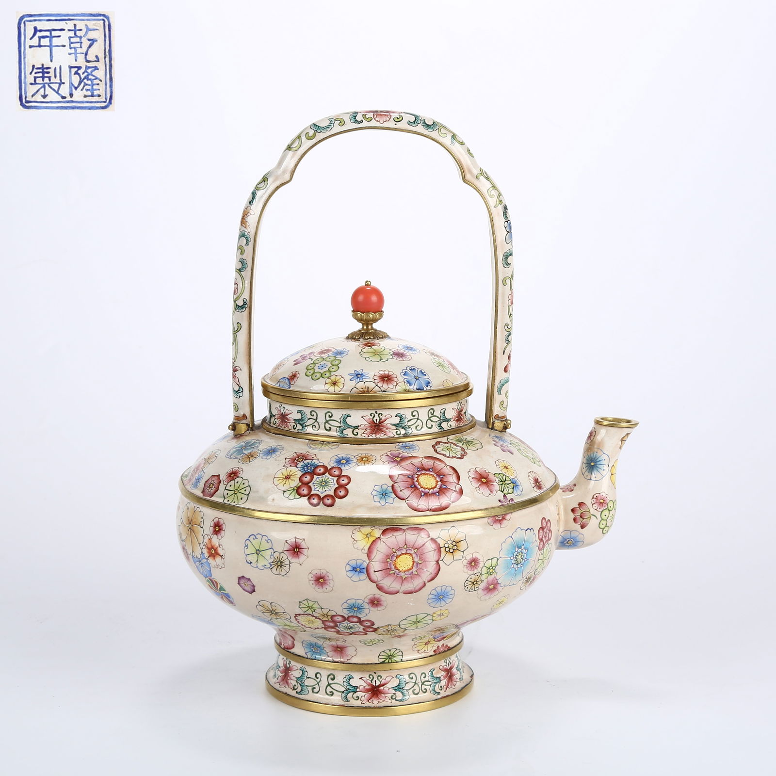 A CLOISONNÉ ENAMELED EWER WITH BROCADE BALL PATTERN AND SWING HANDLE: Cloisonné enameled ewer with brocade ball pattern and swing handle