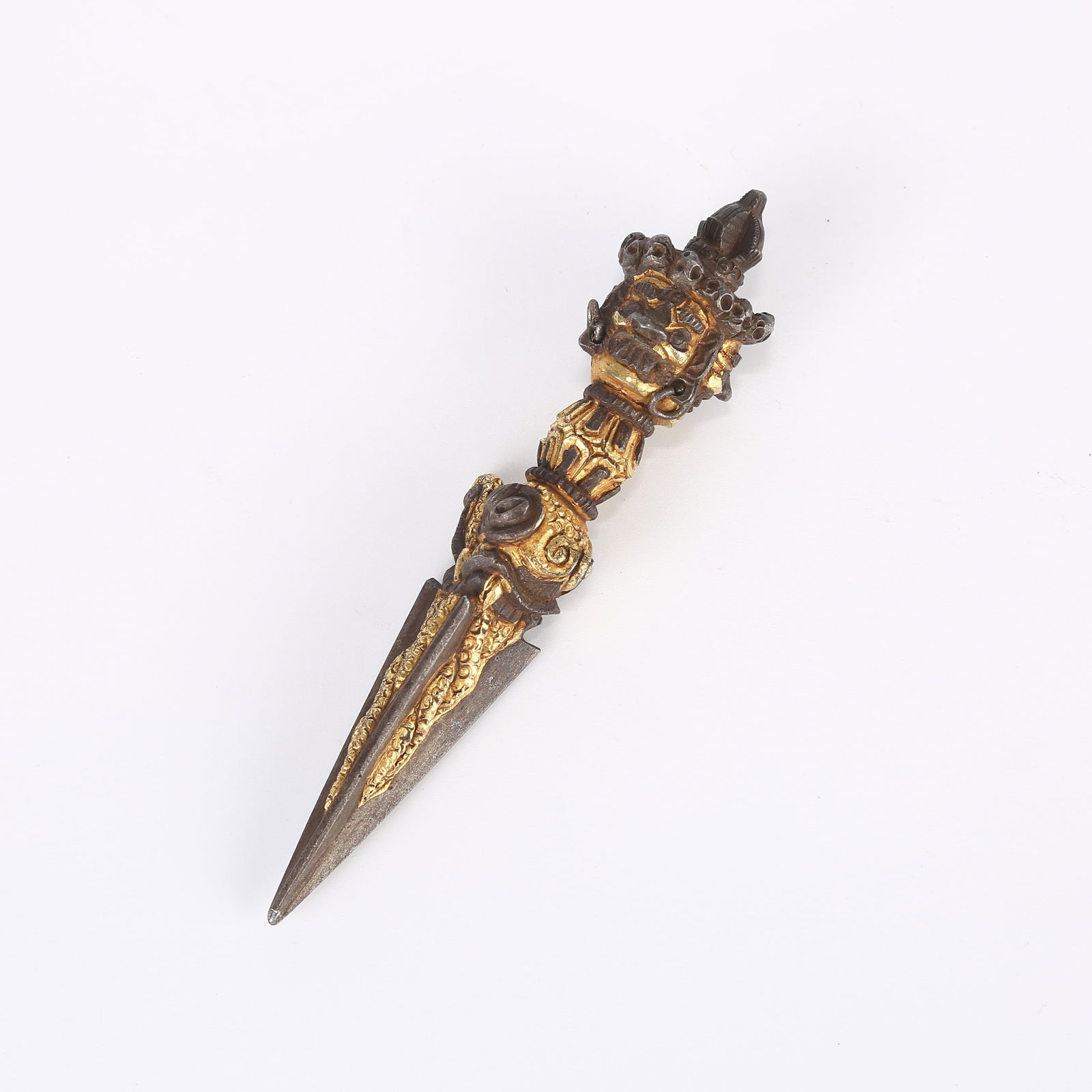 A PARTIALLY GILDED IRON PHURBA VAJRA RITUAL DAGGER (1 of 6)
