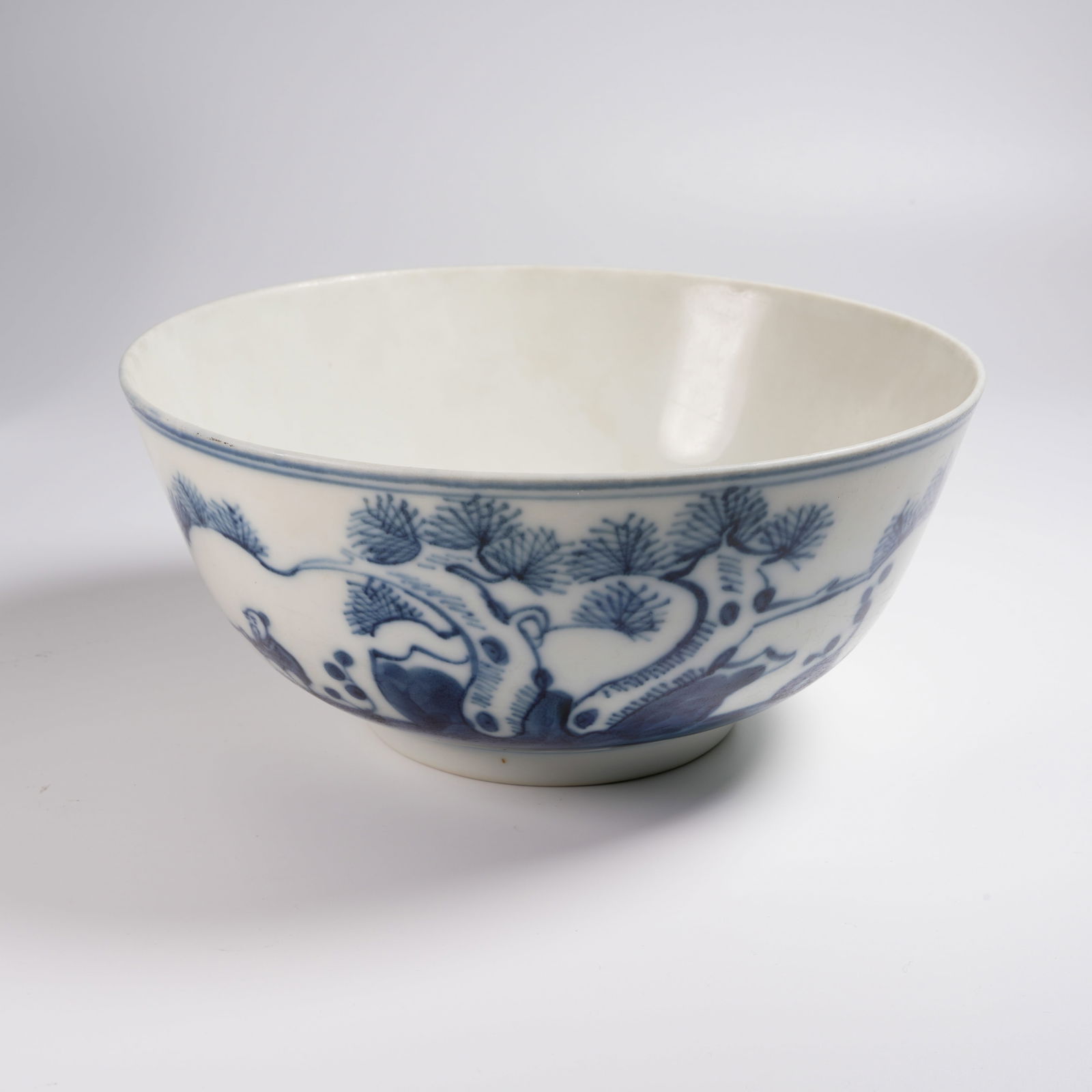 A BLUE-AND-WHITE LARGE BOWL WITH "OLD MAN FISHING BENEATH PINE TREES" SCENE: Blue-and-White Large Bowl with "Old Man Fishing beneath Pine Trees" Scene