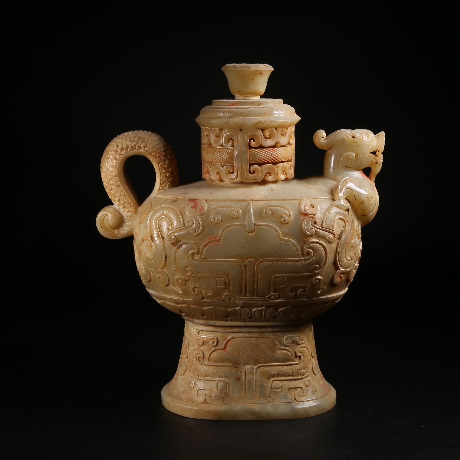 A ARCHAIC JADE FLAT VASE WITH DRAGON-HEAD FINIAL: Archaic jade flat vase with dragon-head finial