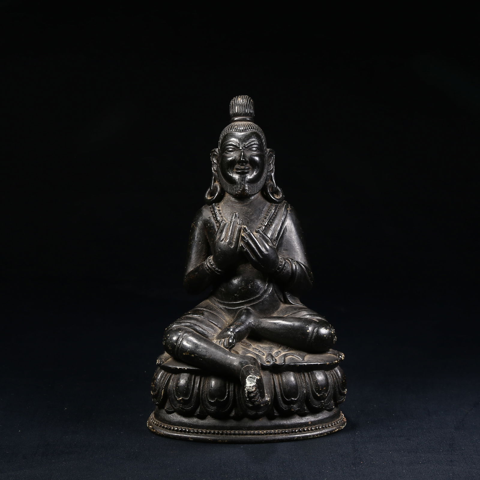 A STATUE OF THE GREAT ACCOMPLISHED ONE IN BLACK STONE: Statue of the Great Accomplished One in Black Stone