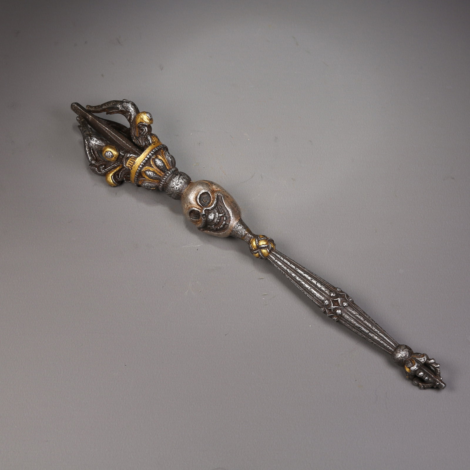 A IRON RITUAL IMPLEMENT WITH GOLD OVERLAY: Iron ritual implement with gold overlay