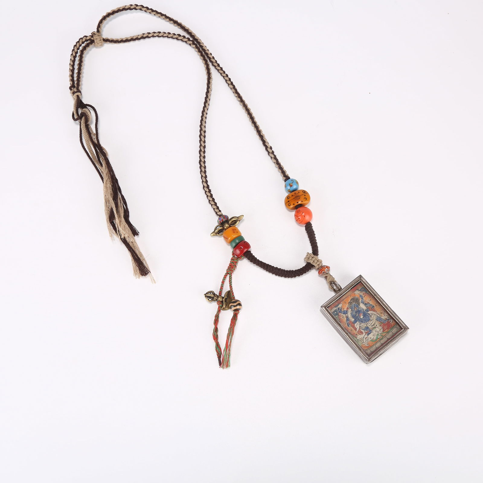 A SIX-ARMED MAHAKALA TANKA WITH SILVER CASE: Six-armed Mahakala tanka with silver case