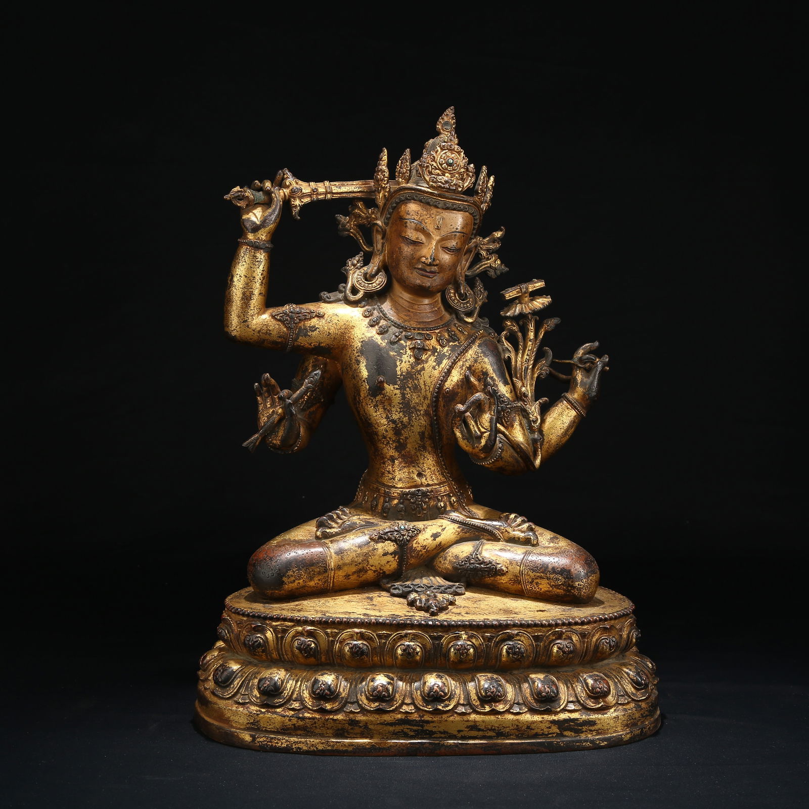 A GILT BRONZE FOUR-ARMED MANJUSHRI BODHISATTVA STATUE: Gilt Bronze Four-Armed Manjushri Bodhisattva Statue