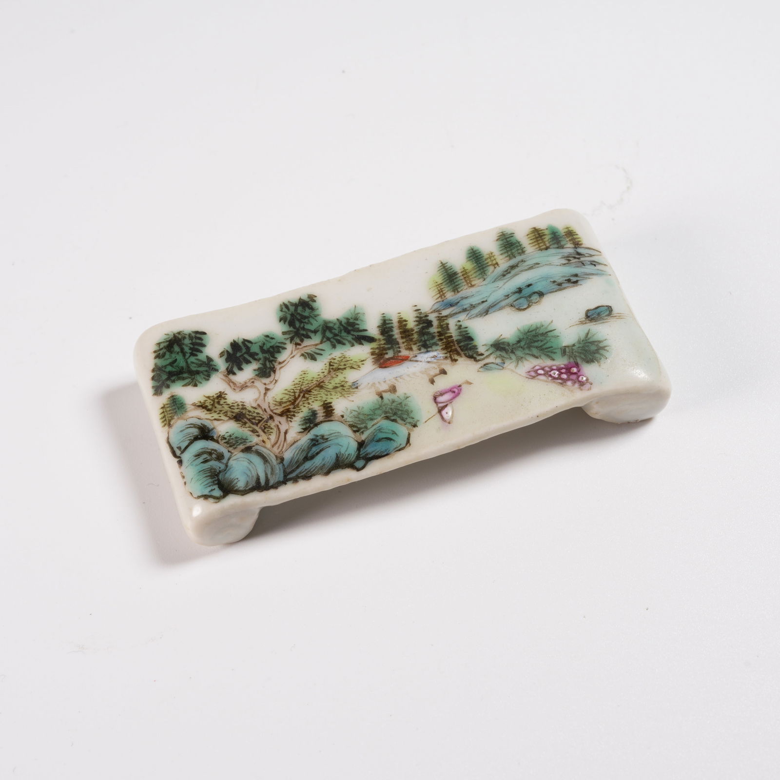 A FAMILLE ROSE LANDSCAPE-DECORATED INK REST: Famille Rose Landscape-Decorated Ink Rest