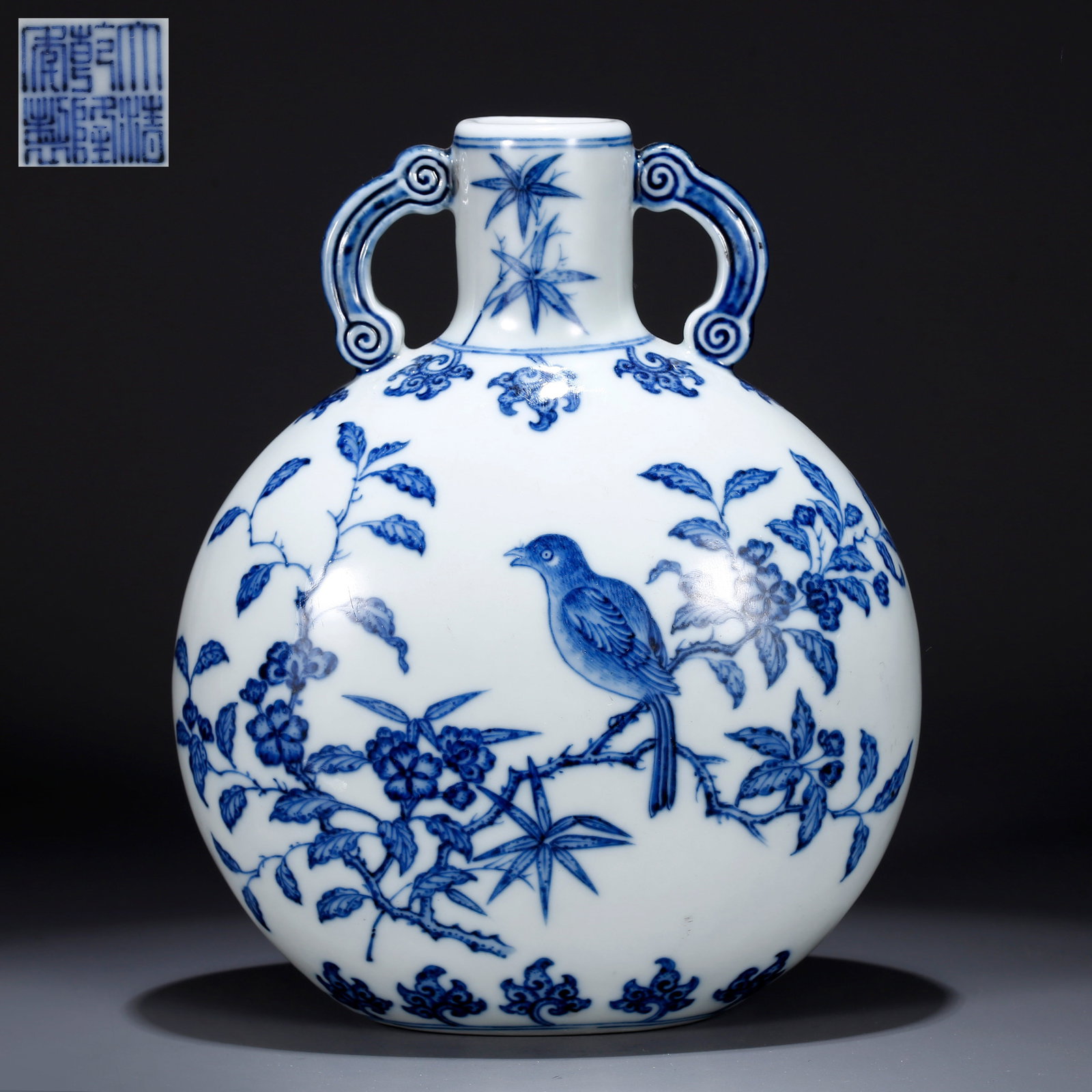 A BLUE AND WHITE FLORAL-PATTERNED MOON-HOLDING VASE: Blue and white floral-patterned moon-holding vase