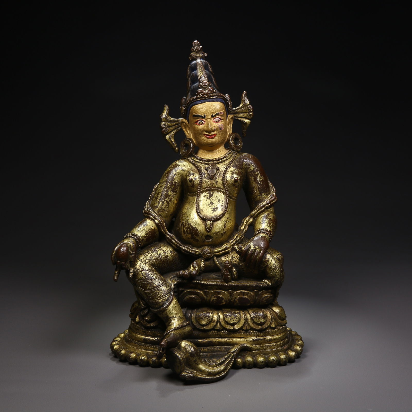A GILDED BRONZE YELLOW JAMBHALA STATUE IN PALA STYLE: Gilded bronze Yellow Jambhala statue in Pala style