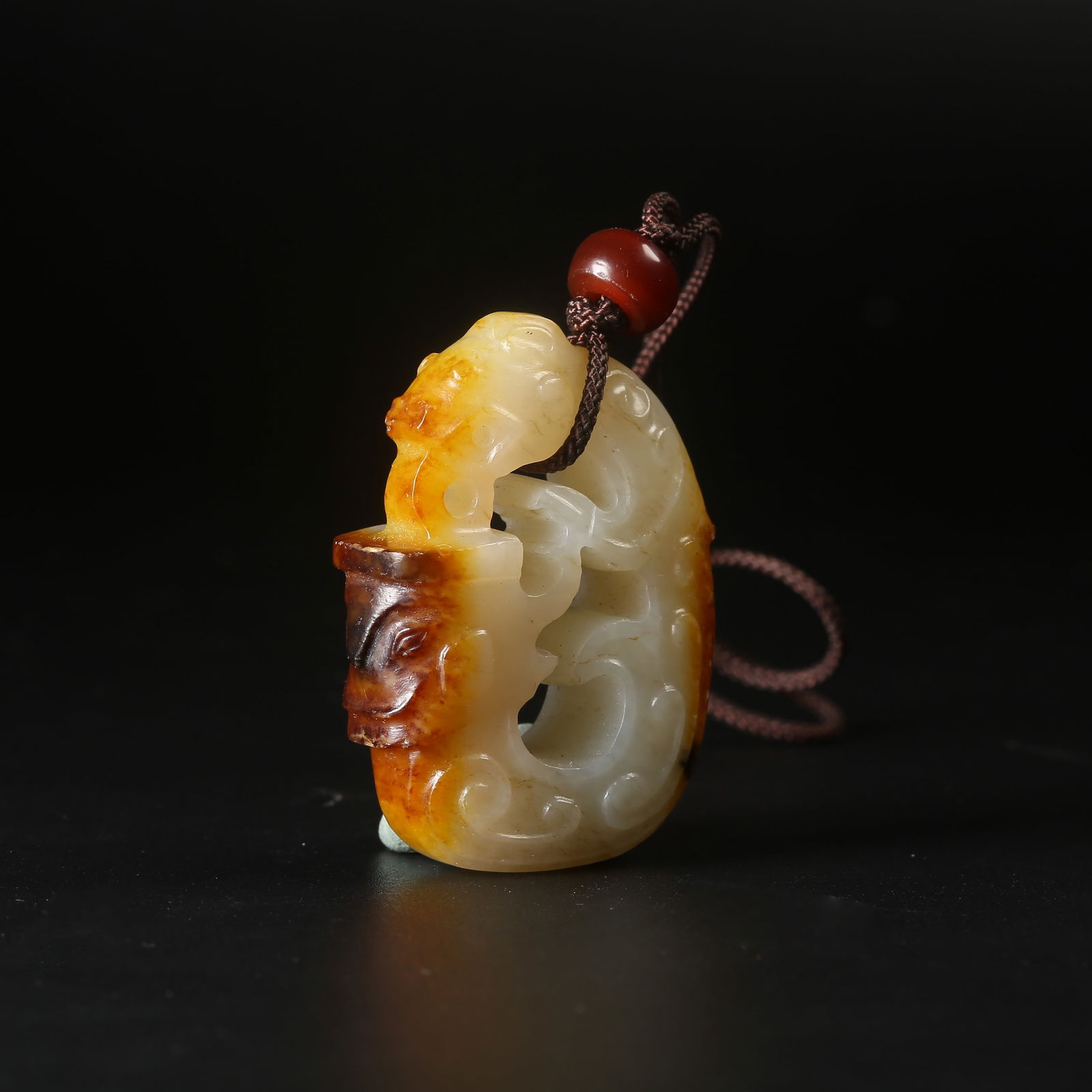 A ARCHAIC JADE PENDANT WITH DEITY MASK MOTIF: Archaic Jade Pendant with Deity Mask Motif