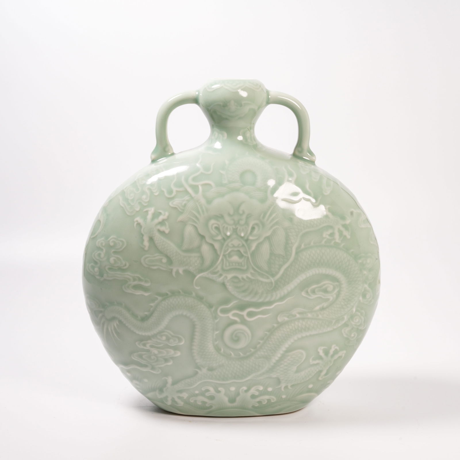 A CELADON-GLAZED VASE WITH CLOUD-AND-DRAGON DESIGN AND RIBBON HANDLES: Celadon-Glazed Vase with Cloud-and-Dragon Design and Ribbon Handles