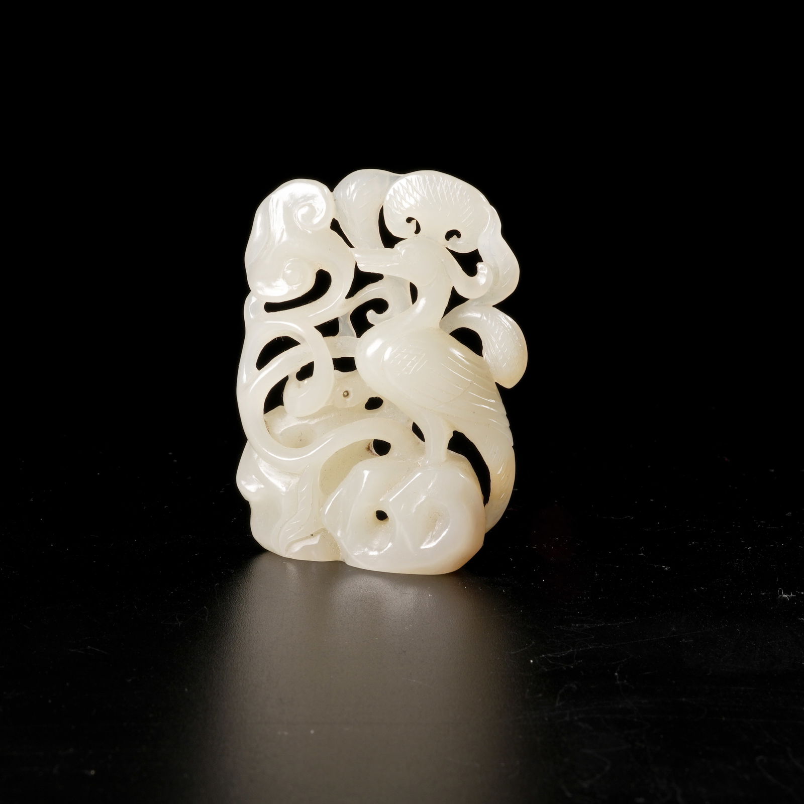 A HETIAN JADE LINGZHI-AND-CRANE MOTIF PENDANT (1 of 8)