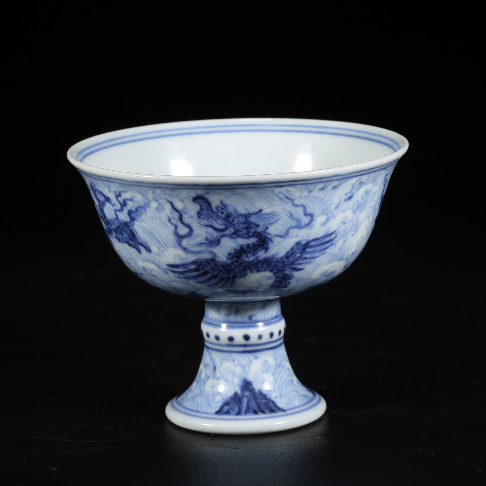 A BLUE-AND-WHITE HIGH-FOOTED CUP WITH SEA-HORSE AND MYTHICAL BEAST PATTERN: Blue-and-White High-Footed Cup with Sea-Horse and Mythical Beast Pattern