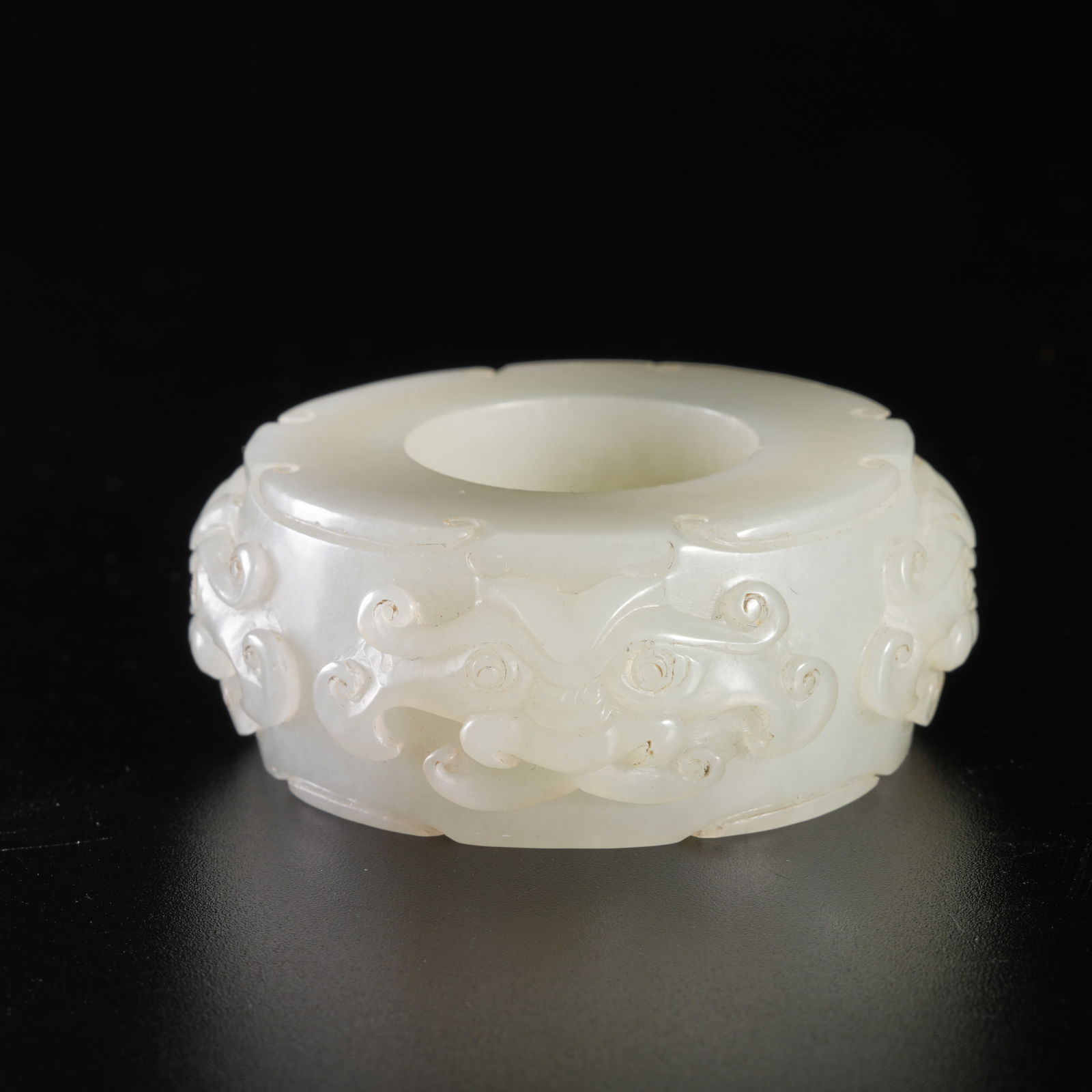 A HETIAN JADE CARVING WITH BEAST-MASK MOTIF PENDANT: Hetian jade carving with beast-mask motif pendant