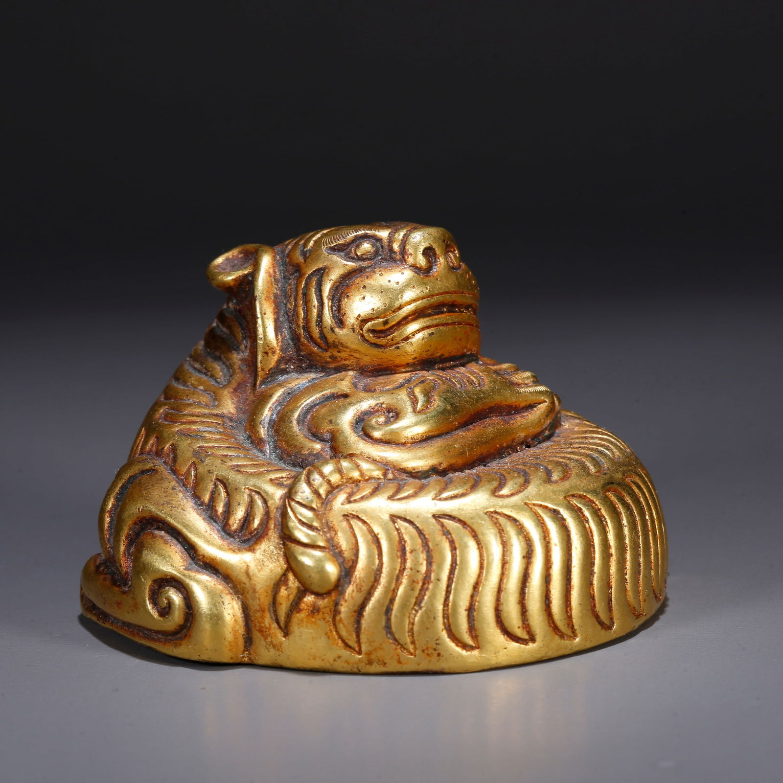 A GILT BRONZE TIGER-SHAPED ORNAMENT: Gilt bronze tiger-shaped ornament