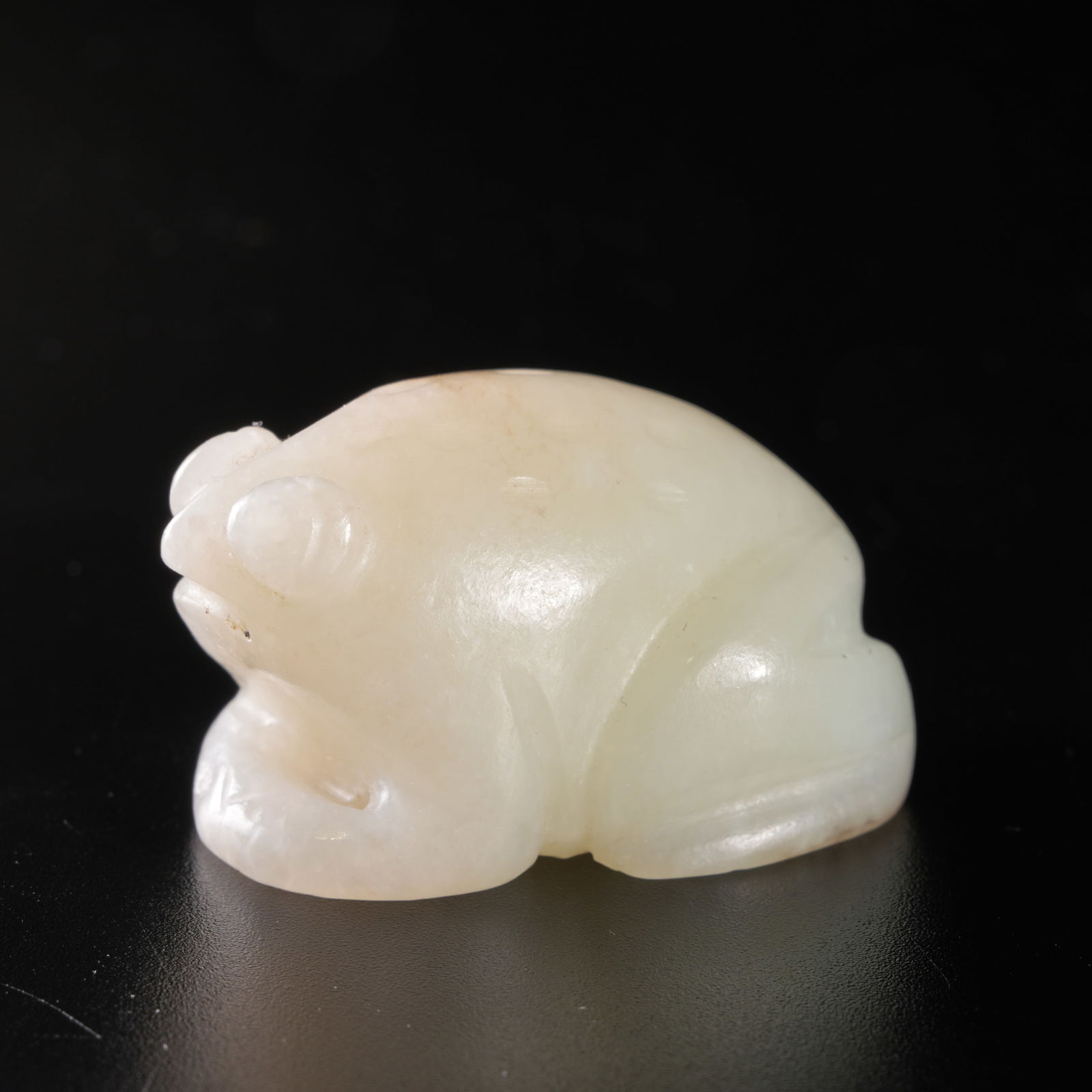 A HETIAN JADE CARVED FROG-FORM DISPLAY PIECE: Hetian jade carved frog-form display piece