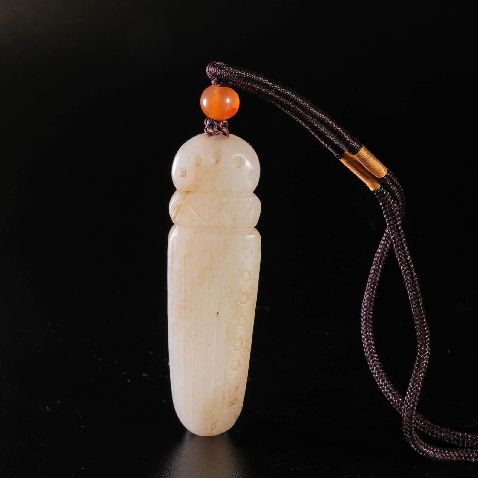 A HETIAN JADE CARVED QIN-SHAPED PENDANT: Hetian jade carved qin-shaped pendant