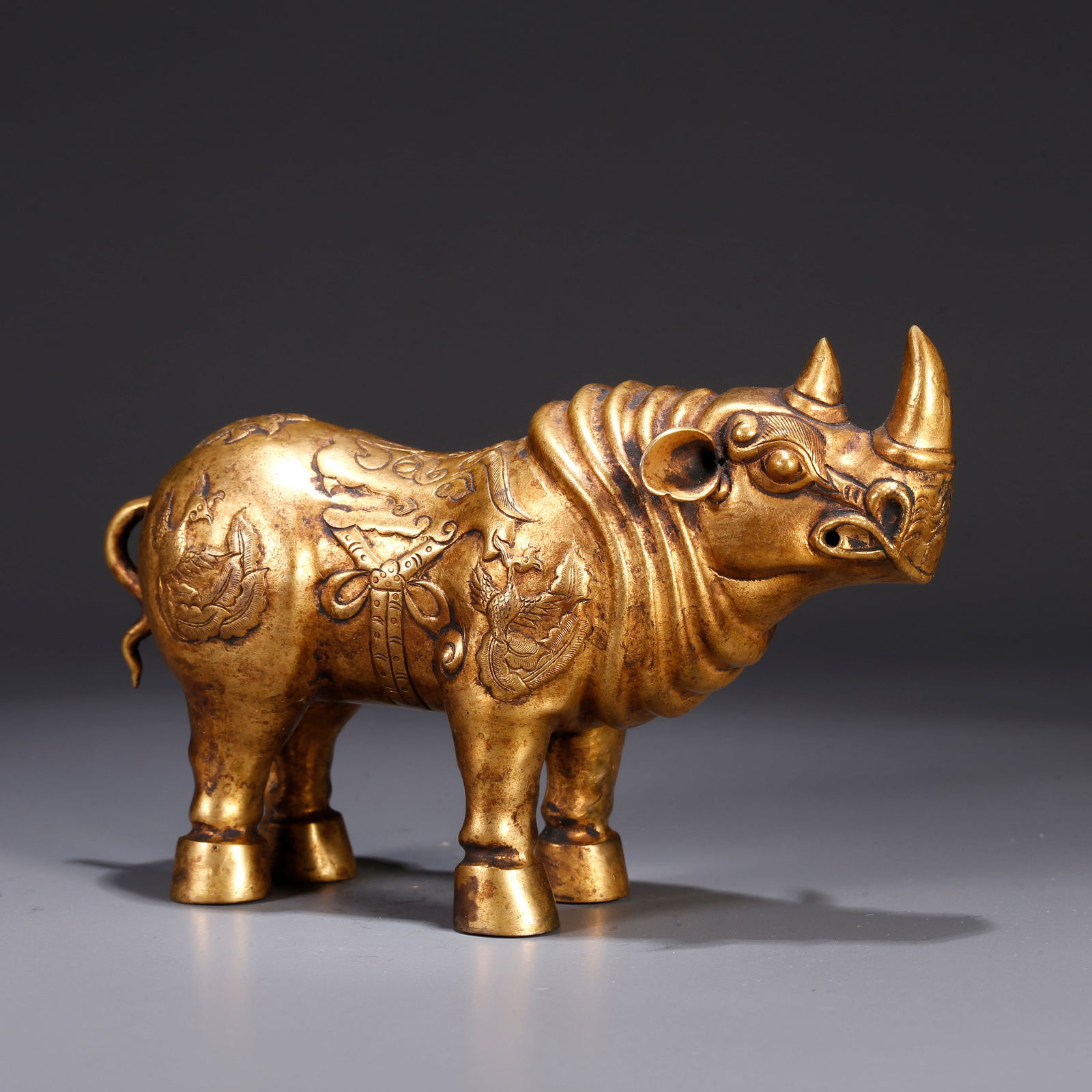 A GILT BRONZE KUI-OX SHAPED ORNAMENT: Gilt bronze kui-ox shaped ornament