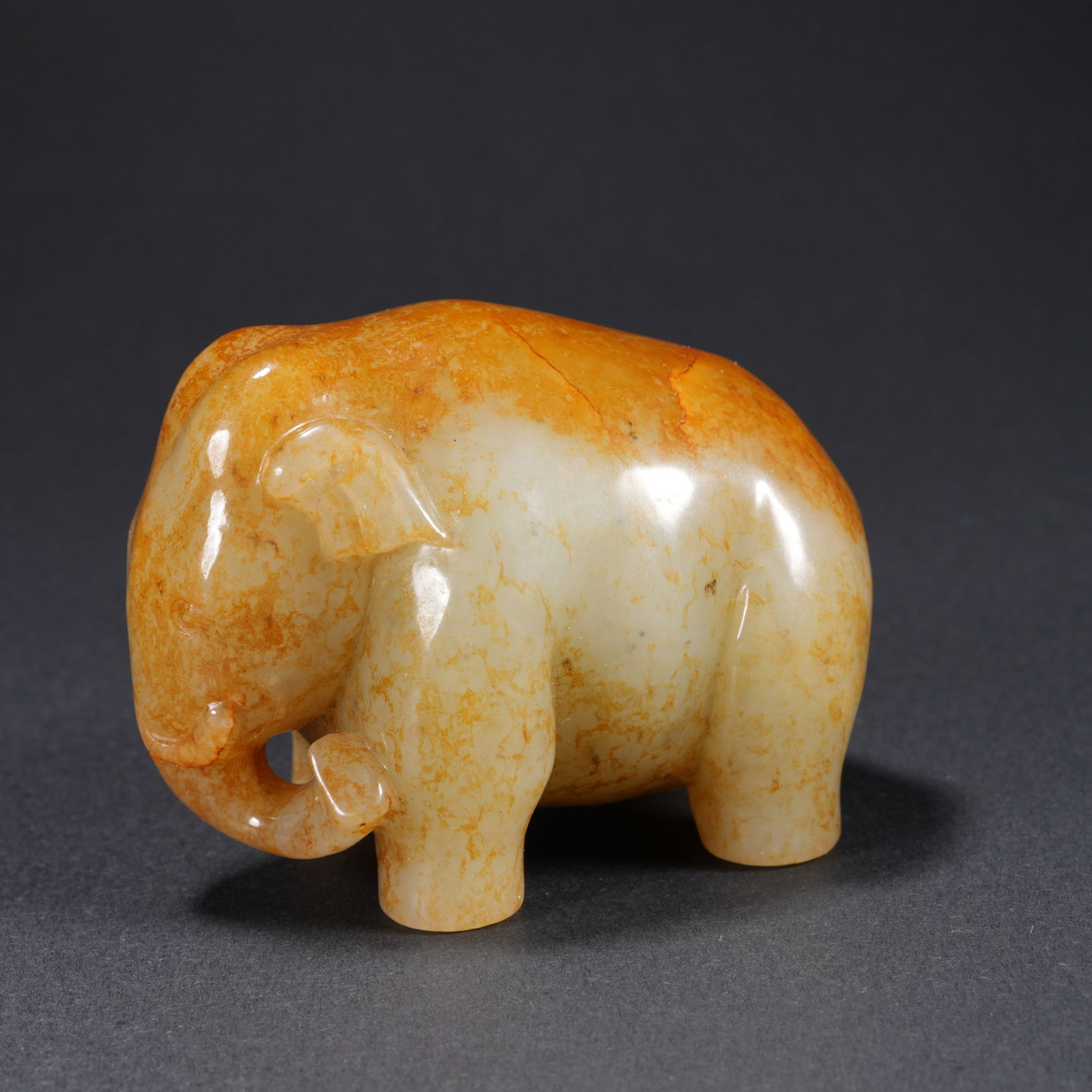 A HETIAN JADE CARVED "PEACE AND PROSPERITY" ELEPHANT-FORM FIGURE: Hetian Jade Carved "Peace and Prosperity" Elephant-Form Figure