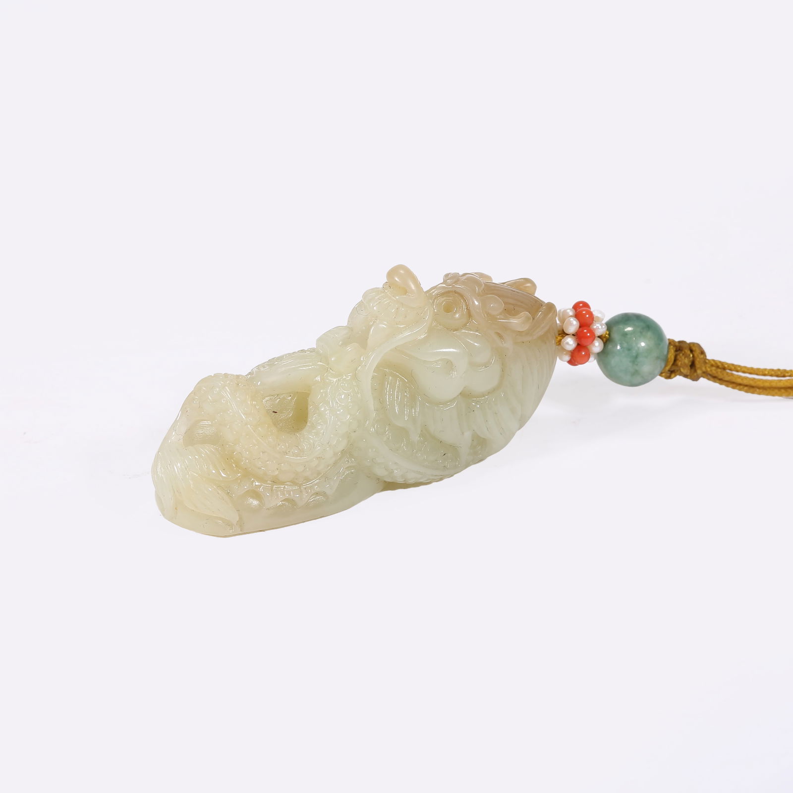 A HETIAN JADE DRAGON-SHAPED PENDANT (1 of 7)