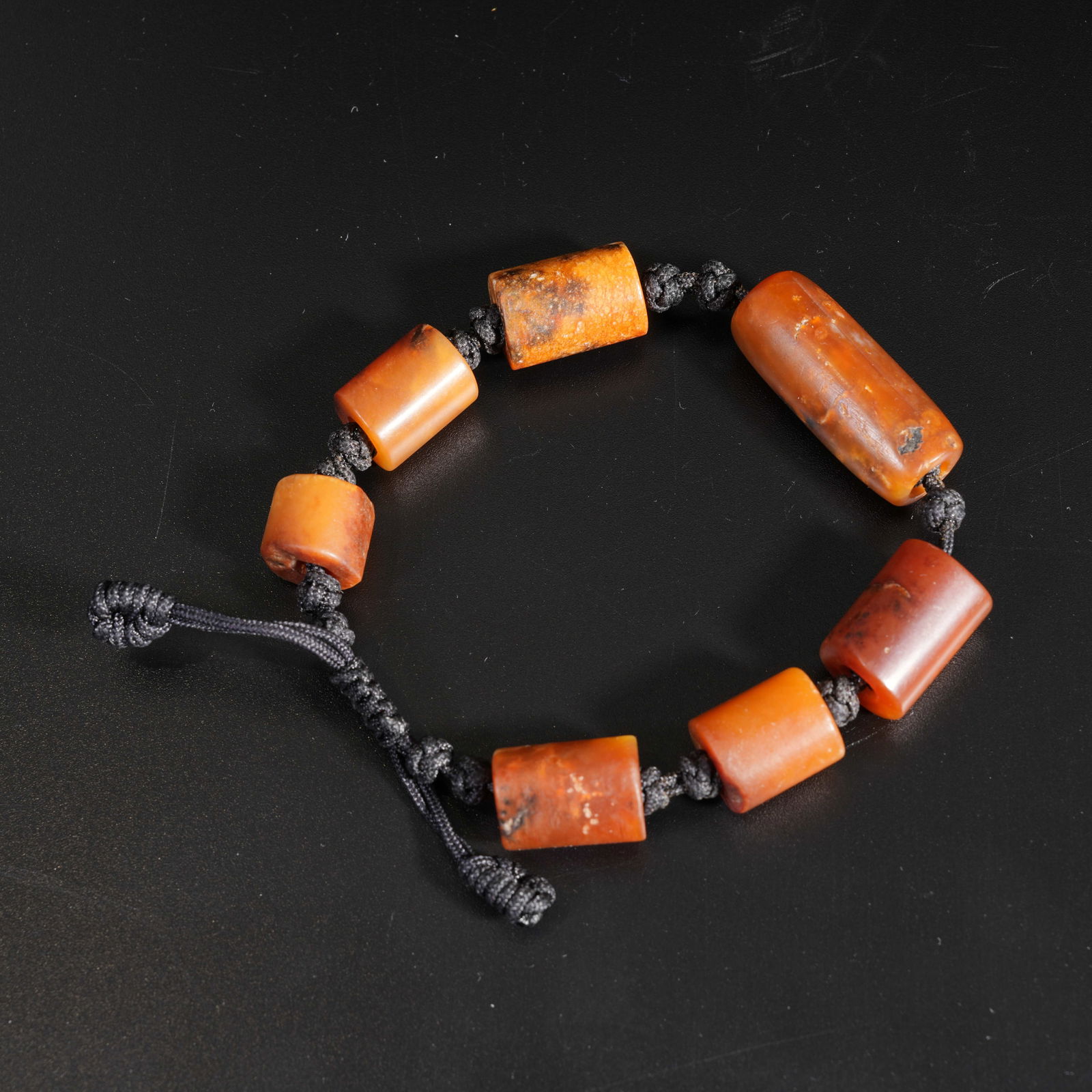 A ARCHAIC JADE CARVED BEAD BRACELET: Archaic jade carved bead bracelet