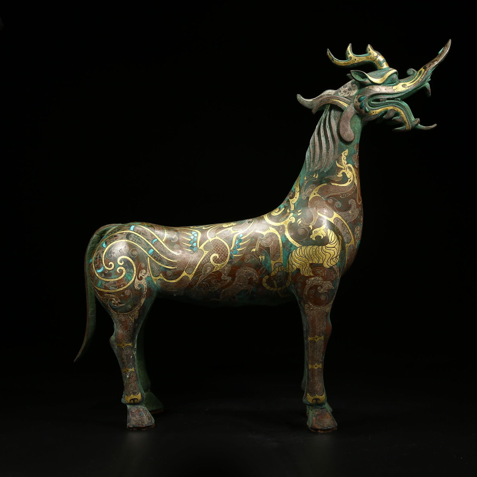 A BRONZE QILIN ORNAMENT INLAID WITH GOLD AND SILVER: Bronze qilin ornament inlaid with gold and silver
