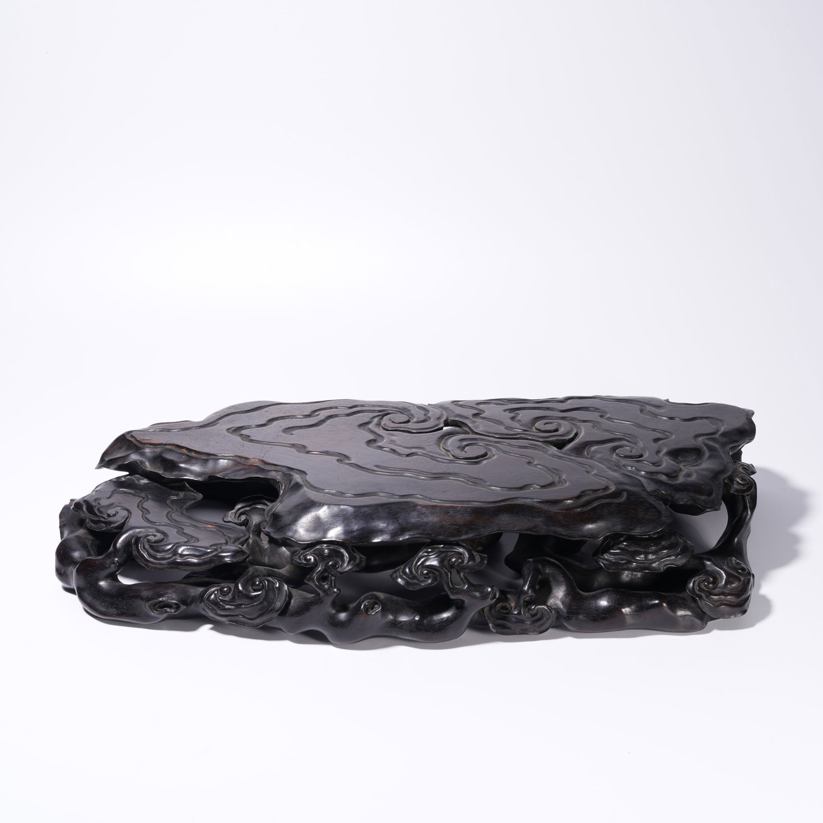 A ZITAN WOOD CARVING AUSPICIOUS CLOUDS AND LINGZHI-PATTERN BASE: Zitan Wood Carving Auspicious Clouds and Lingzhi-Pattern Base