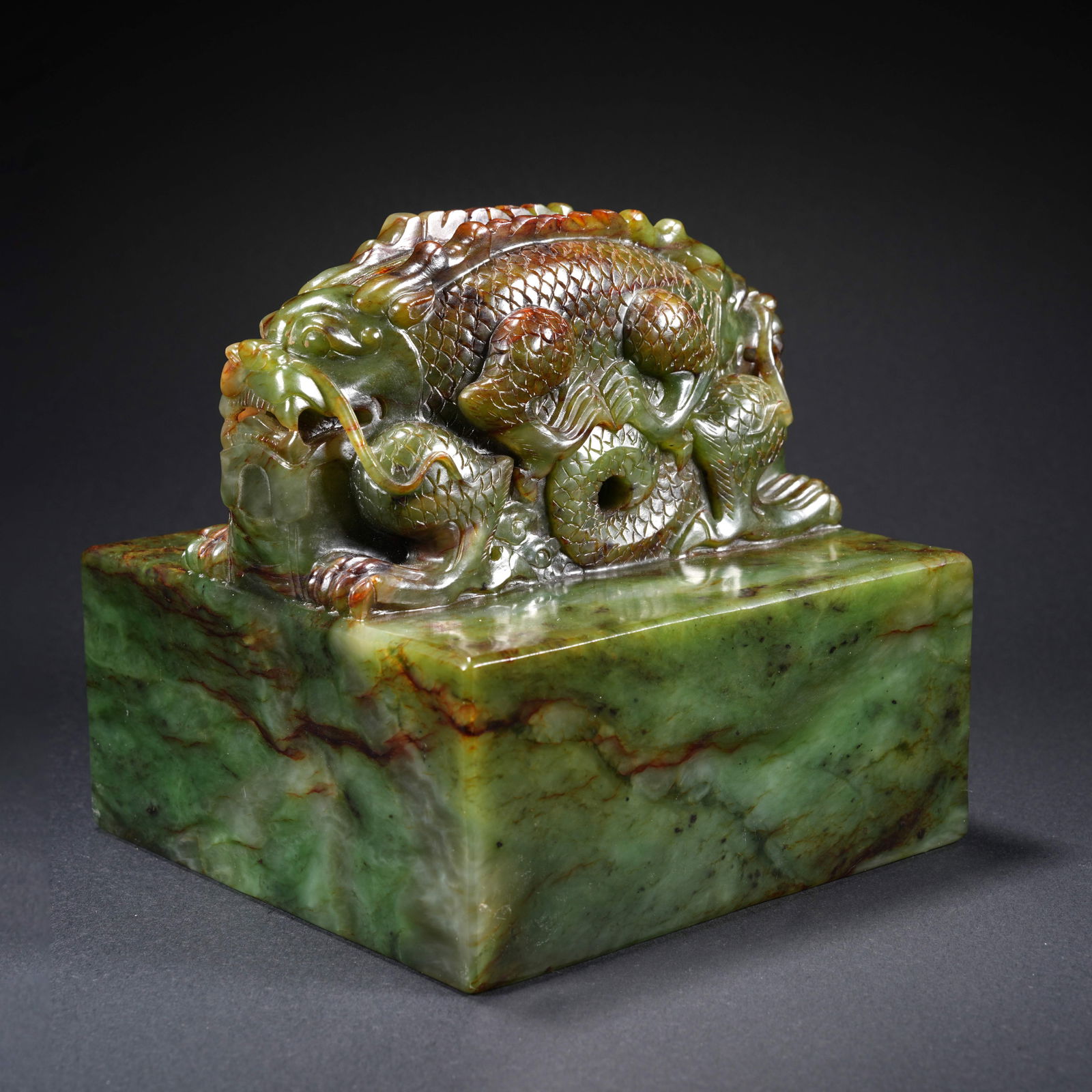 A HETIAN SPINACH GREEN JADE CARVED SEAL WITH DOUBLE-DRAGON FINIAL: Hetian Spinach Green Jade Carved Seal with Double-Dragon Finial