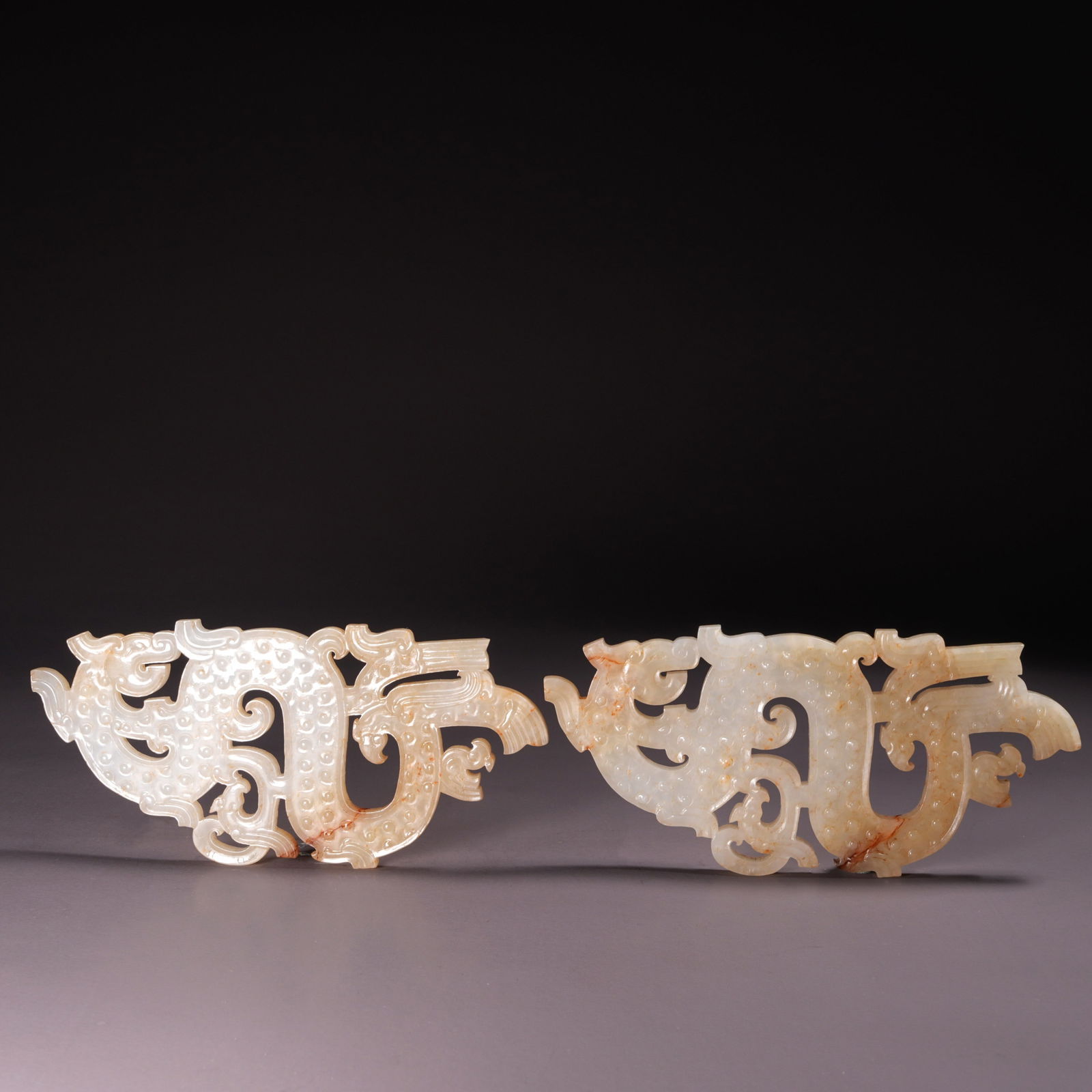 A PAIR OF HETIAN JADE PENDANTS WITH DRAGON MOTIFS: Pair of Hetian Jade Pendants with Dragon Motifs