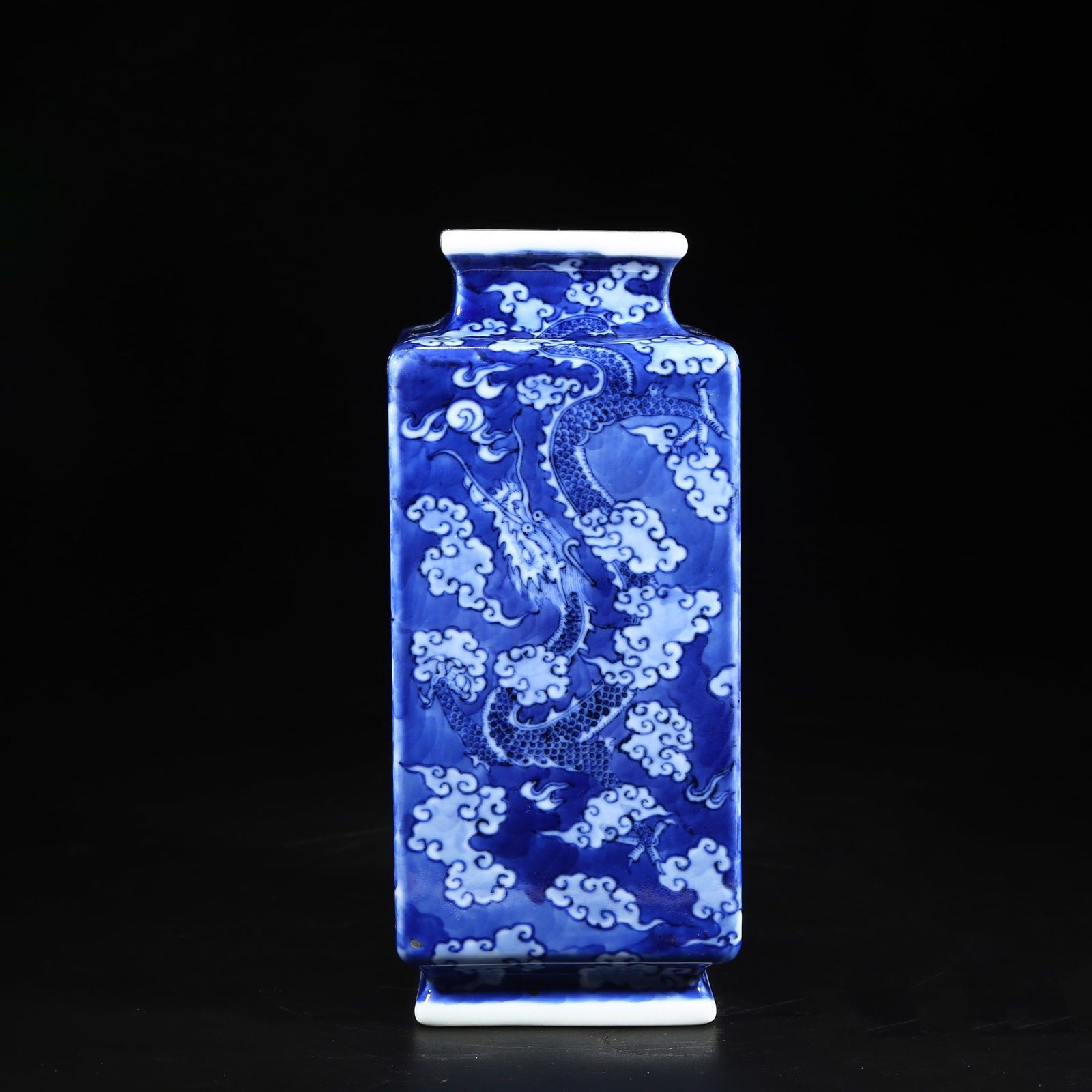A BLUE-AND-WHITE SQUARE VASE WITH CLOUD AND DRAGON PATTERN: Blue-and-White Square Vase with Cloud and Dragon Pattern