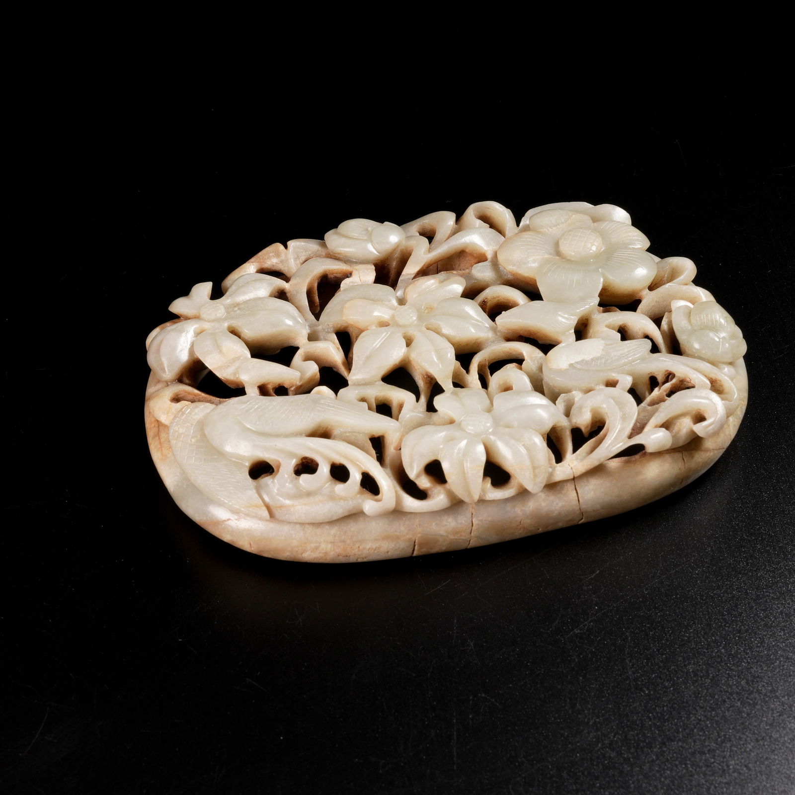 A HETIAN JADE FLORAL-AND-BIRD MOTIF PENDANT: Hetian Jade Floral-and-Bird Motif Pendant