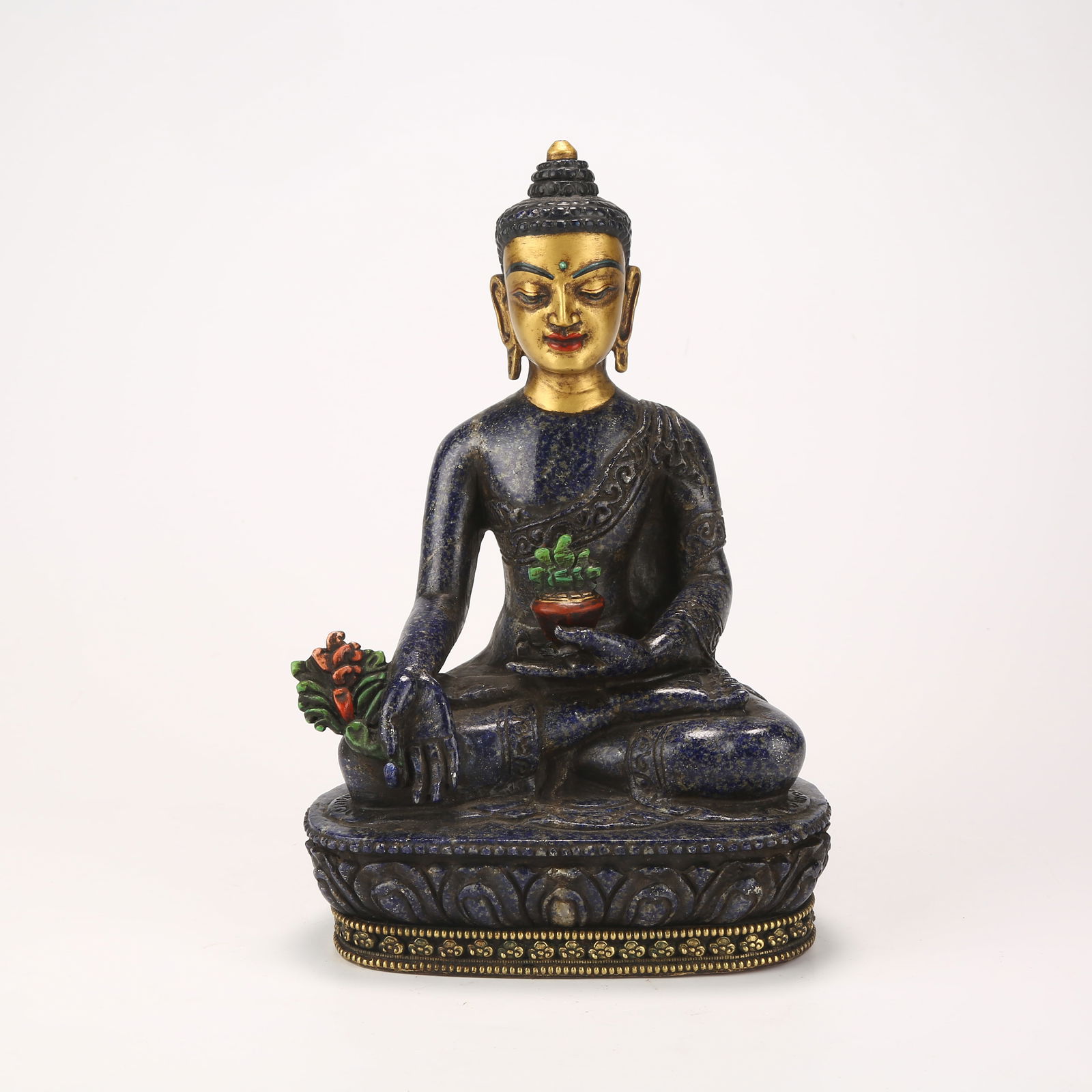 A BHAISAJYAGURU FIGURE IN LAPIS LAZULI: Bhaisajyaguru Figure in Lapis Lazuli