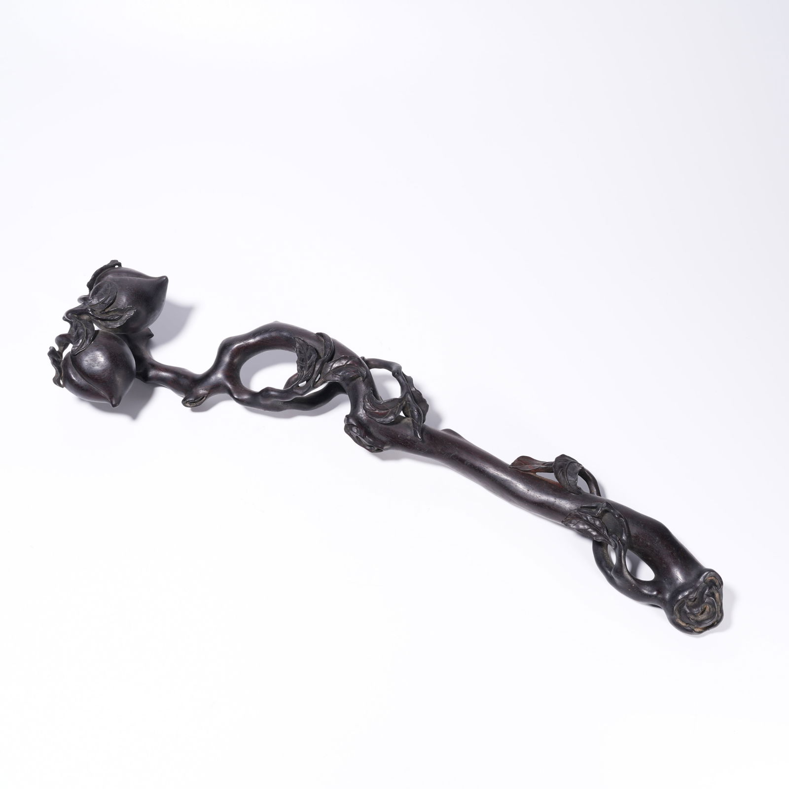 A ZITAN WOOD CARVING LONGEVITY PEACH-PATTERN RUYI: Zitan Wood Carving Longevity Peach-Pattern Ruyi