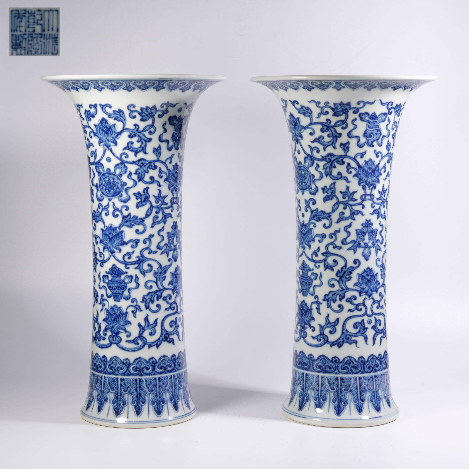 A SET OF BLUE-AND-WHITE HUAGU VASES WITH SCROLLING LOTUS MOTIFS: Set of blue-and-white huagu vases with scrolling lotus motifs