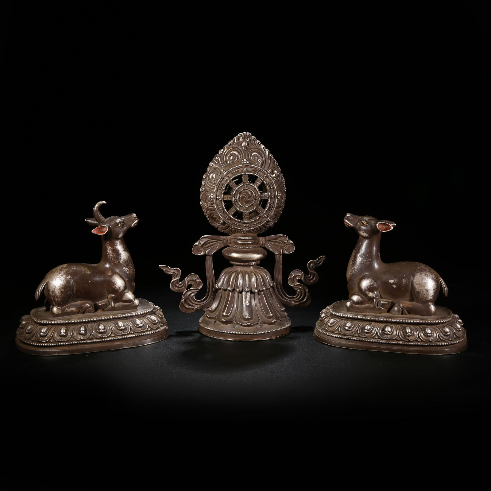 A GILT SILVER PAIR OF DEER AND DHARMA WHEEL SET: Gilt silver pair of deer and Dharma wheel set