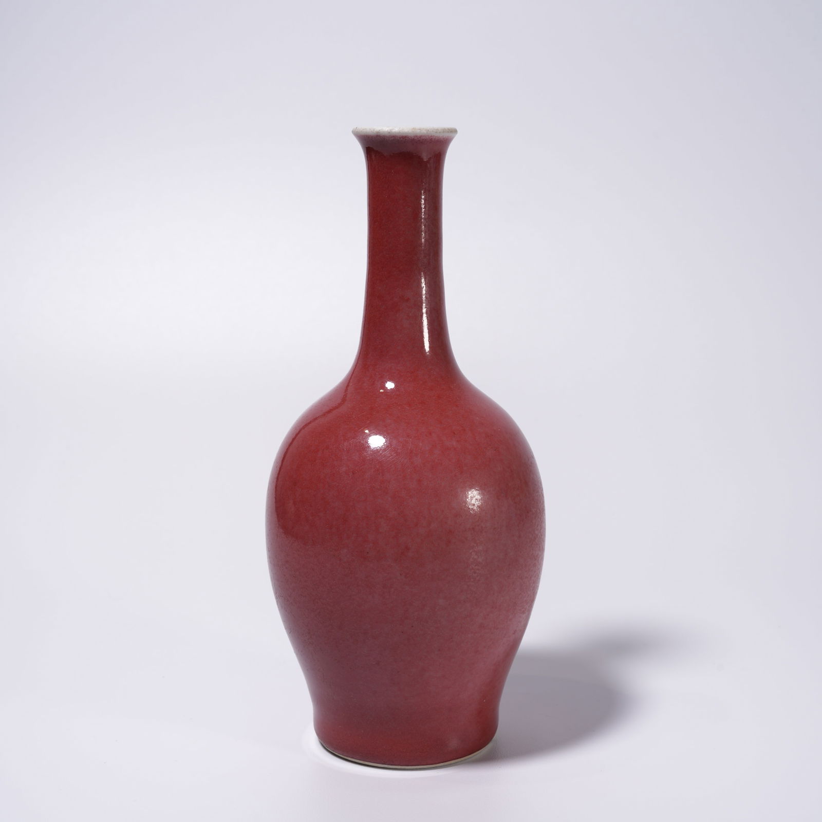 A PEA-GREEN RED-GLAZED SHANG VASE: Pea-green red-glazed shang vase