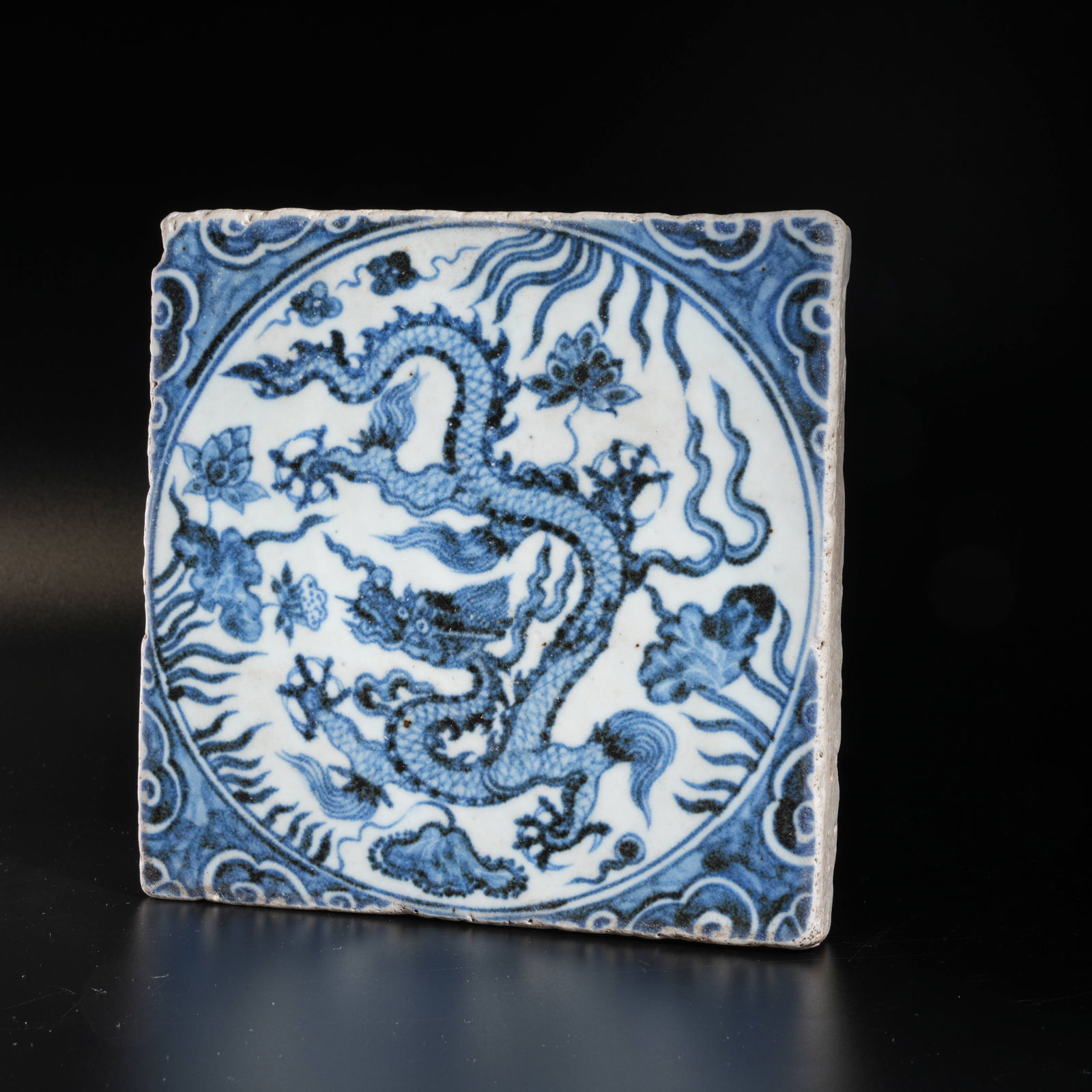 A BLUE-AND-WHITE PORCELAIN PANEL WITH CLOUD-AND-DRAGON MOTIF (1 of 8)